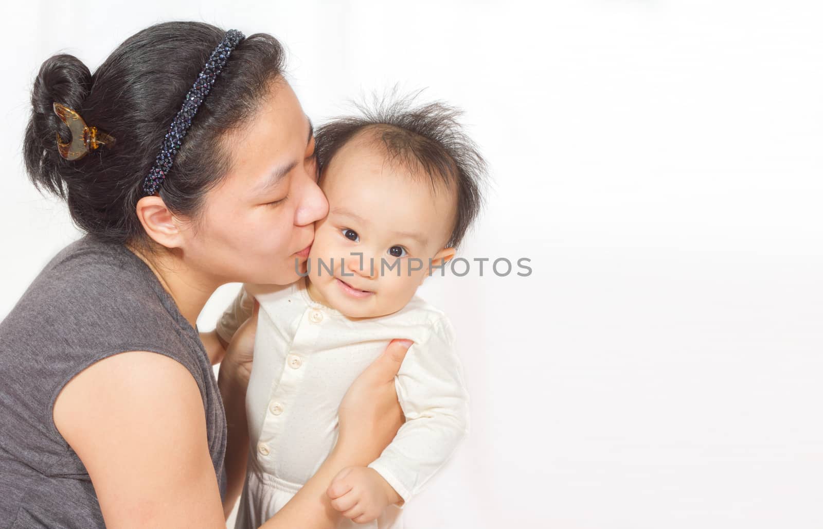 Asian mom holding baby in white background