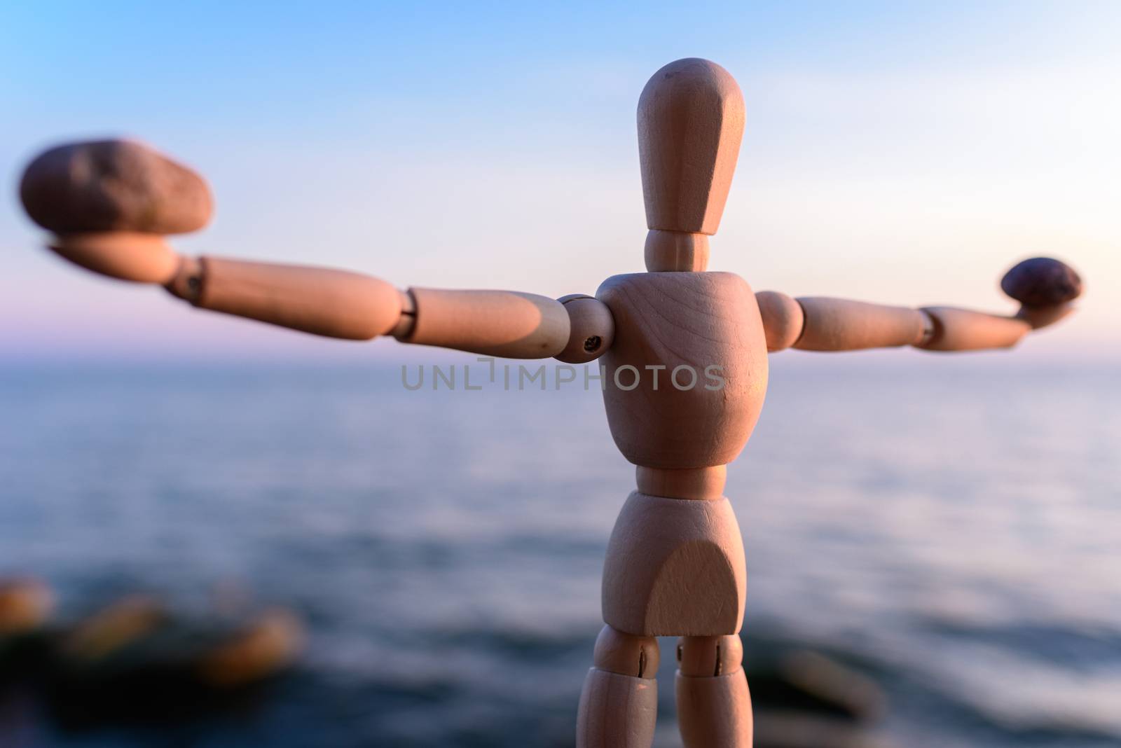 Stones in the hands of a wooden mannequin