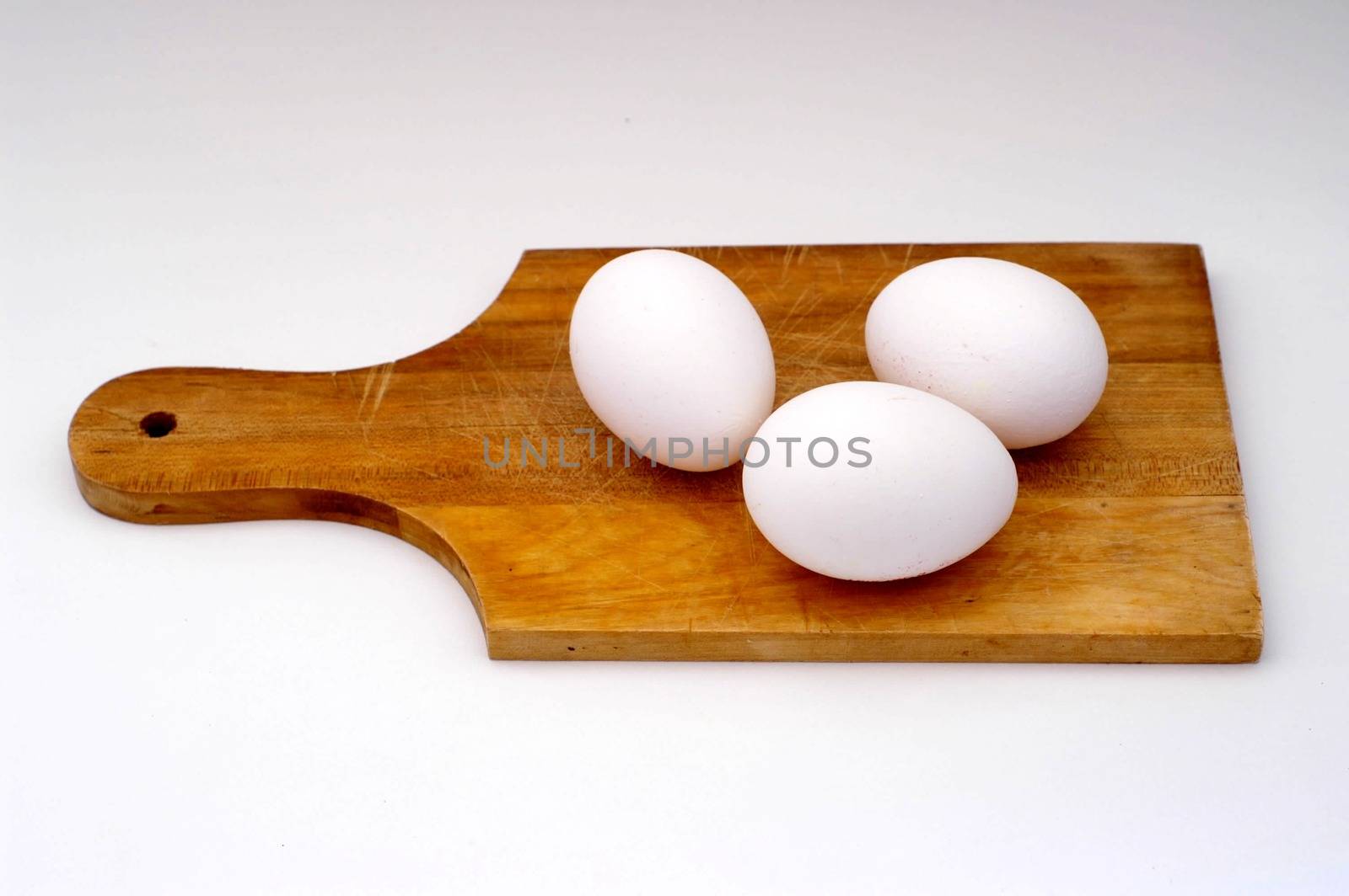 Eggs on a cooking wooden plate