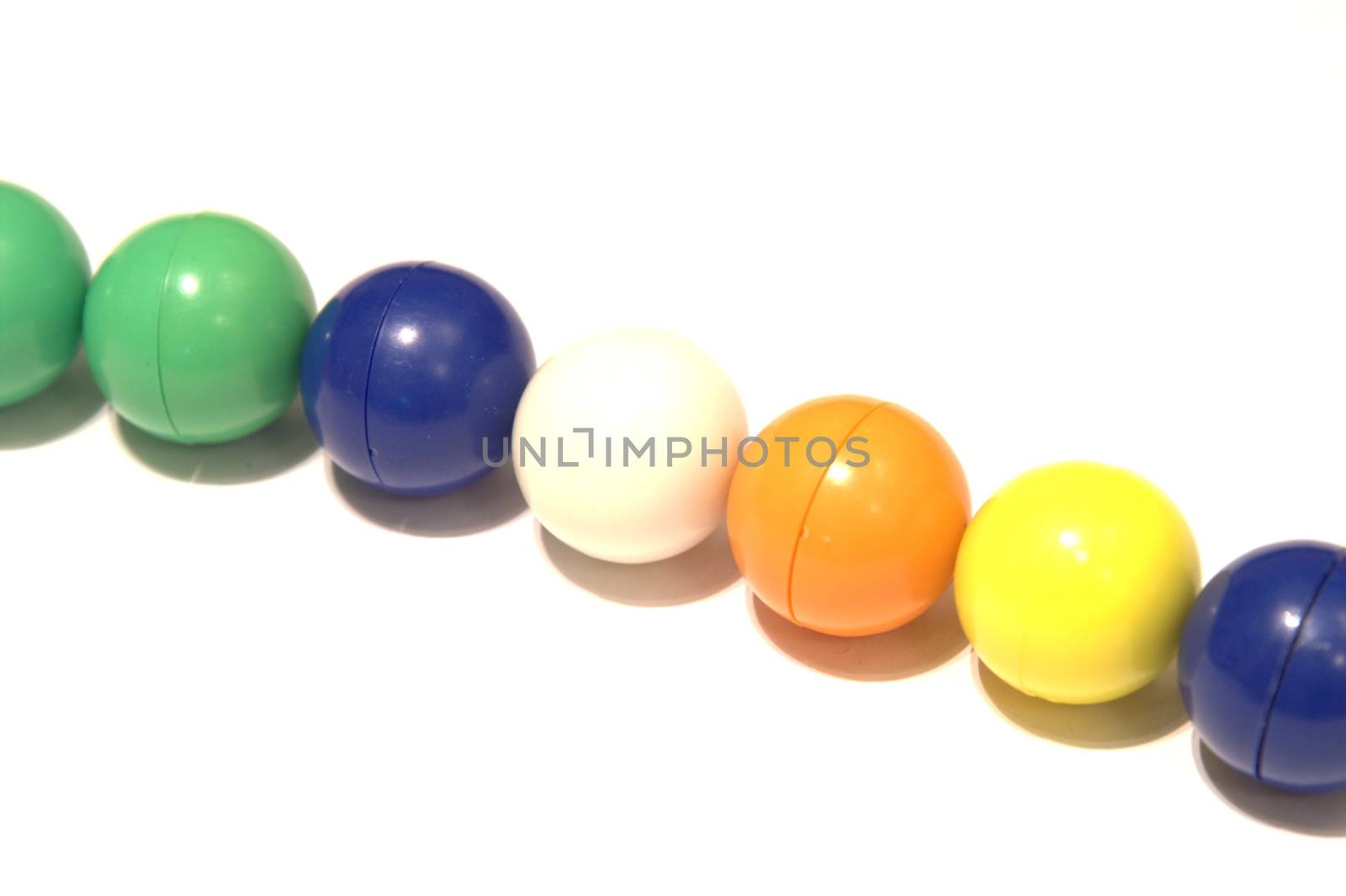 Color balls and a metal ball on white background created an abstract construction, connected, isolated