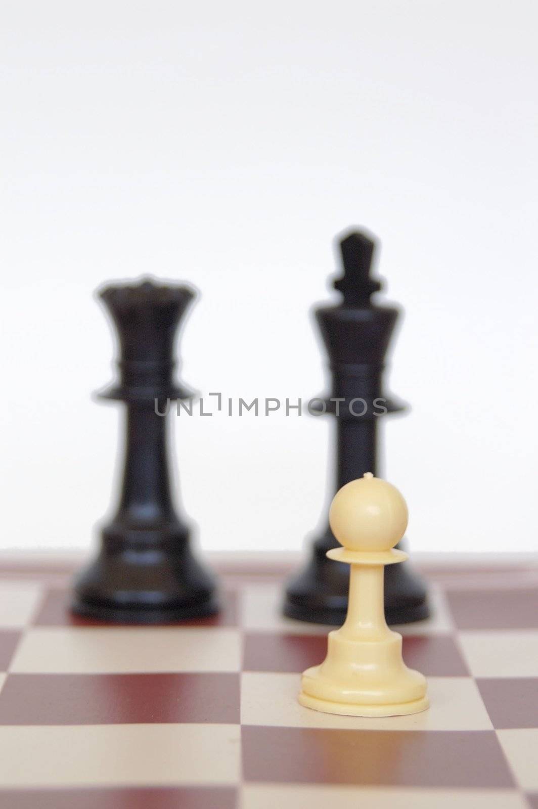 white man with black king and queen on a chess board