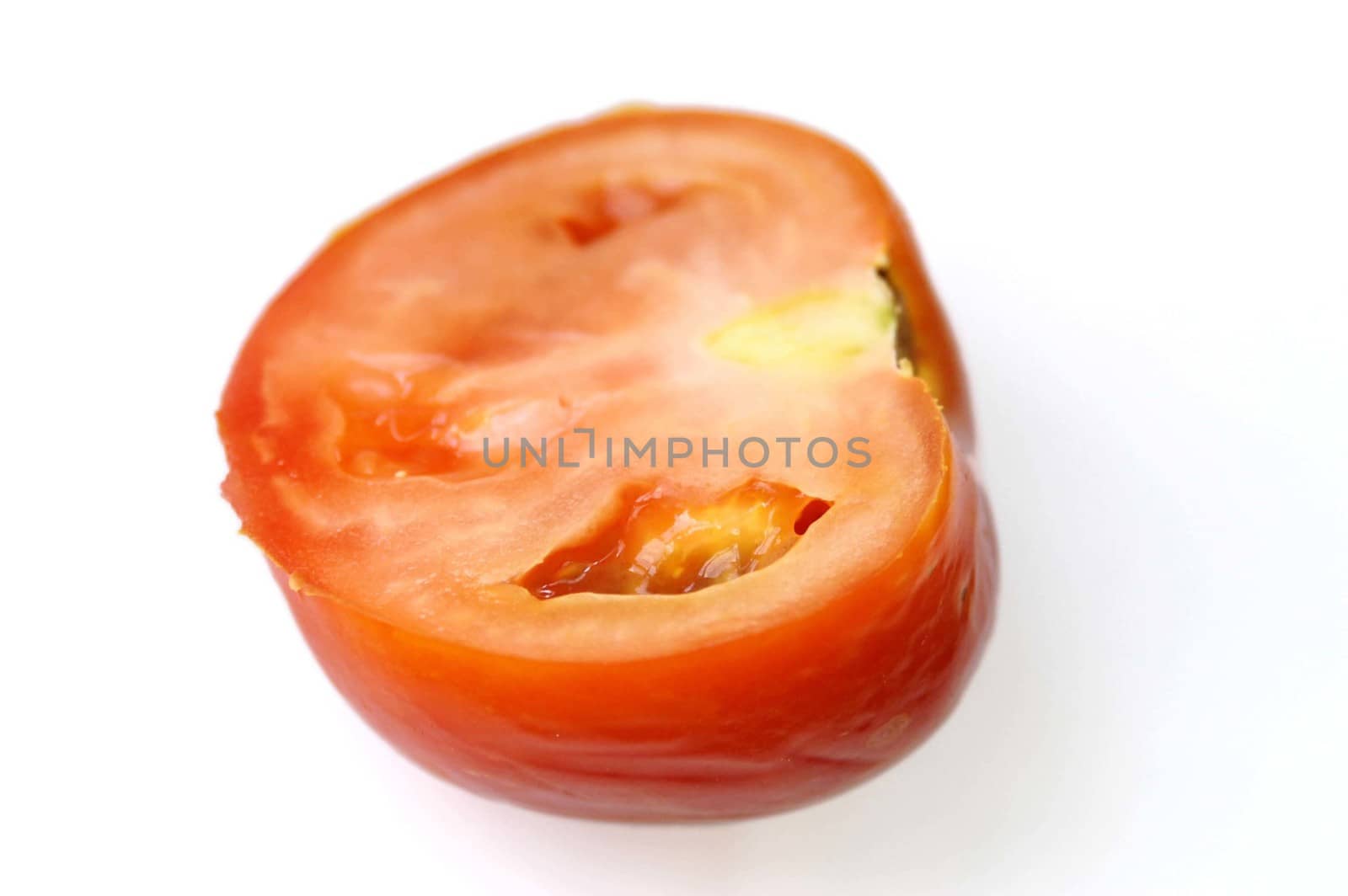 Cutting a tomato with a knife on a coocking desk