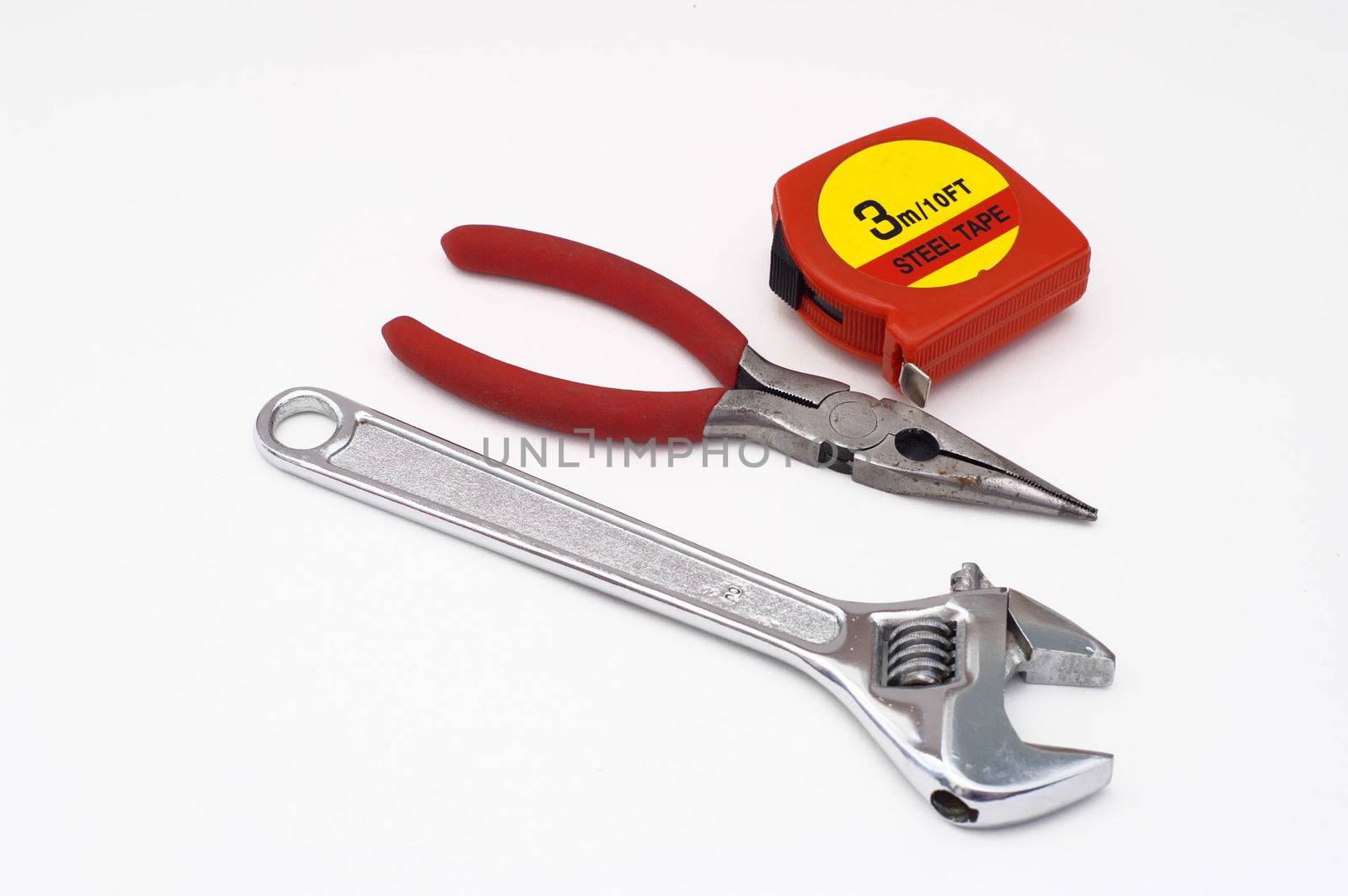 wrench, measuring tape and pliers