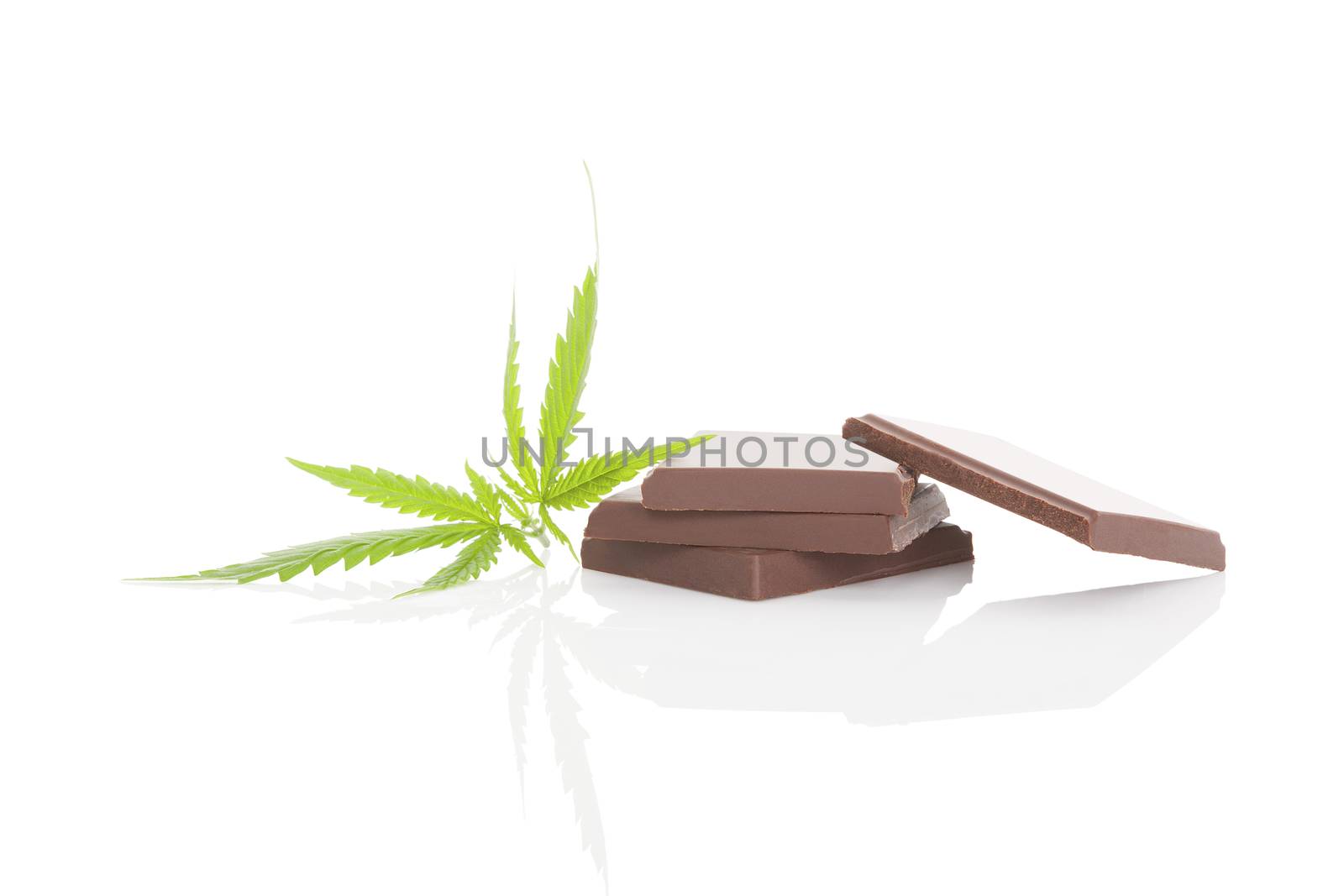 Chocolate bar and cannabis leaf isolated on white background. Cannabis chocolate, edible marijuana.