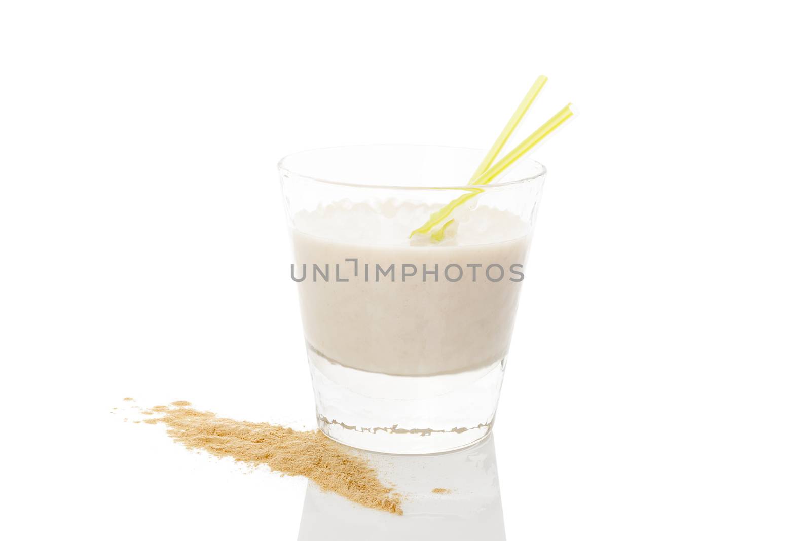 Maca powder on spoon and maca milkshake in glass isolated on white background. Natural alternative medicine.