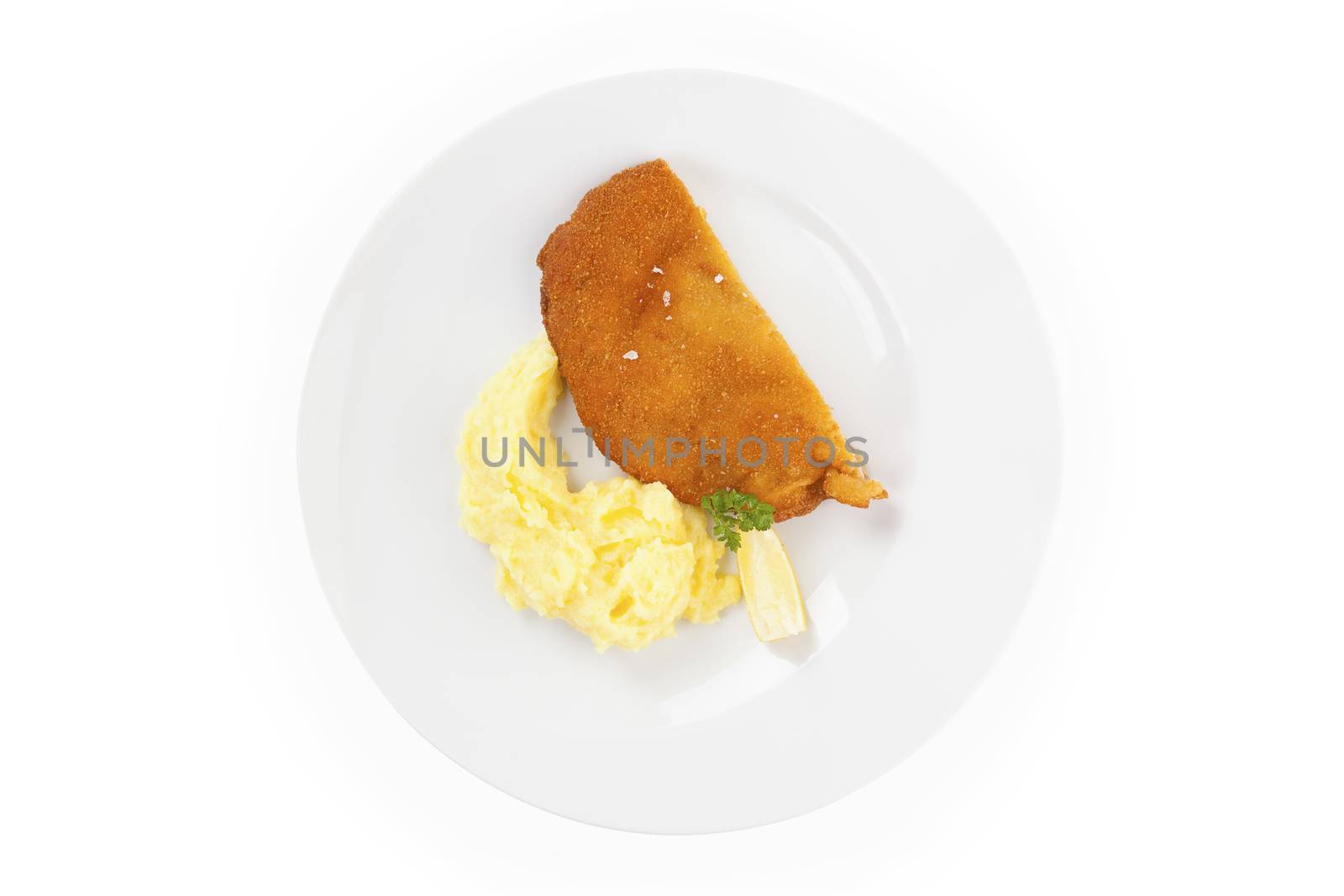 Delicious wiener schnitzel with mashed potatoes on plate on white background, top view. Traditional european cuisine.