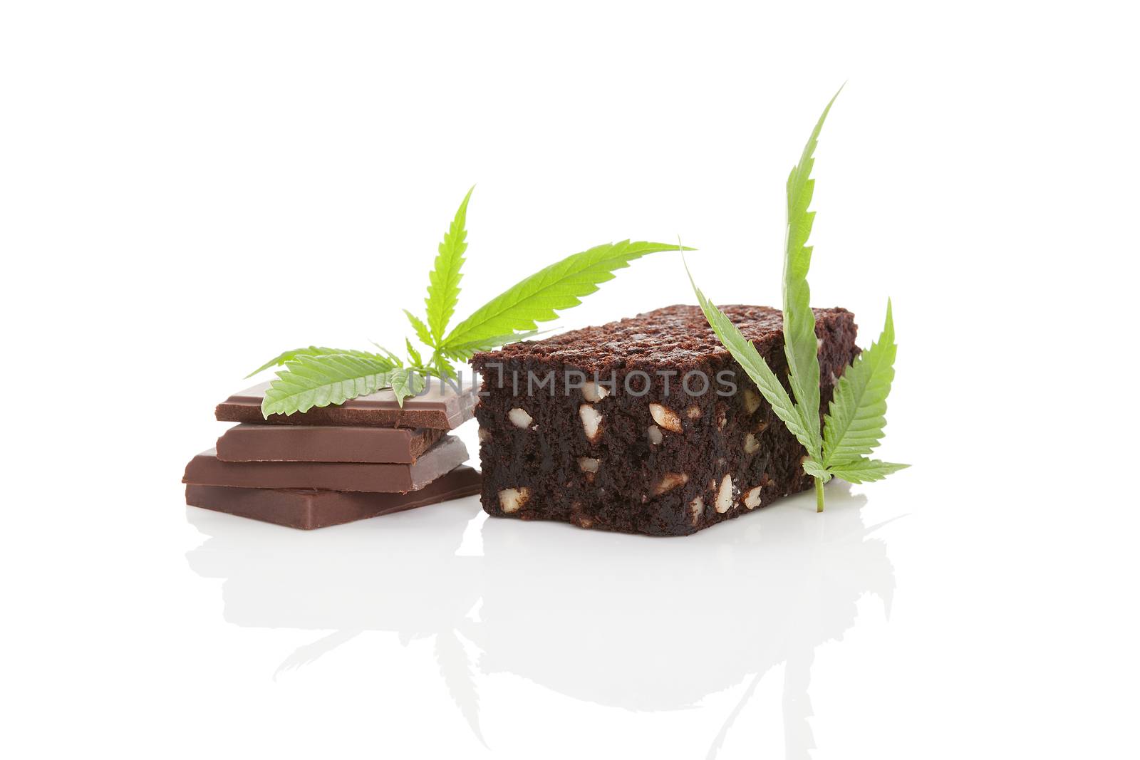 Cannabis chocolate and cannabis brownie with ganja leaf isolated on white background. 
