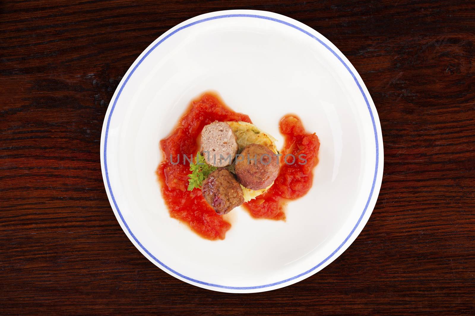 Meatballs with tomato sauce and mashed potatoes on plate on wooden table, top view. Traditional mediterranean eating. 