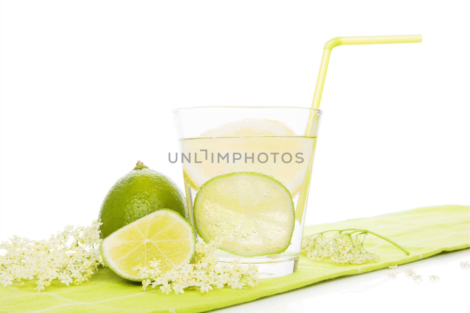 Healthy homemade organic elderberry lemonade with lime slices isolated on white background. Refreshing seasonal nonalcoholic summer drink.