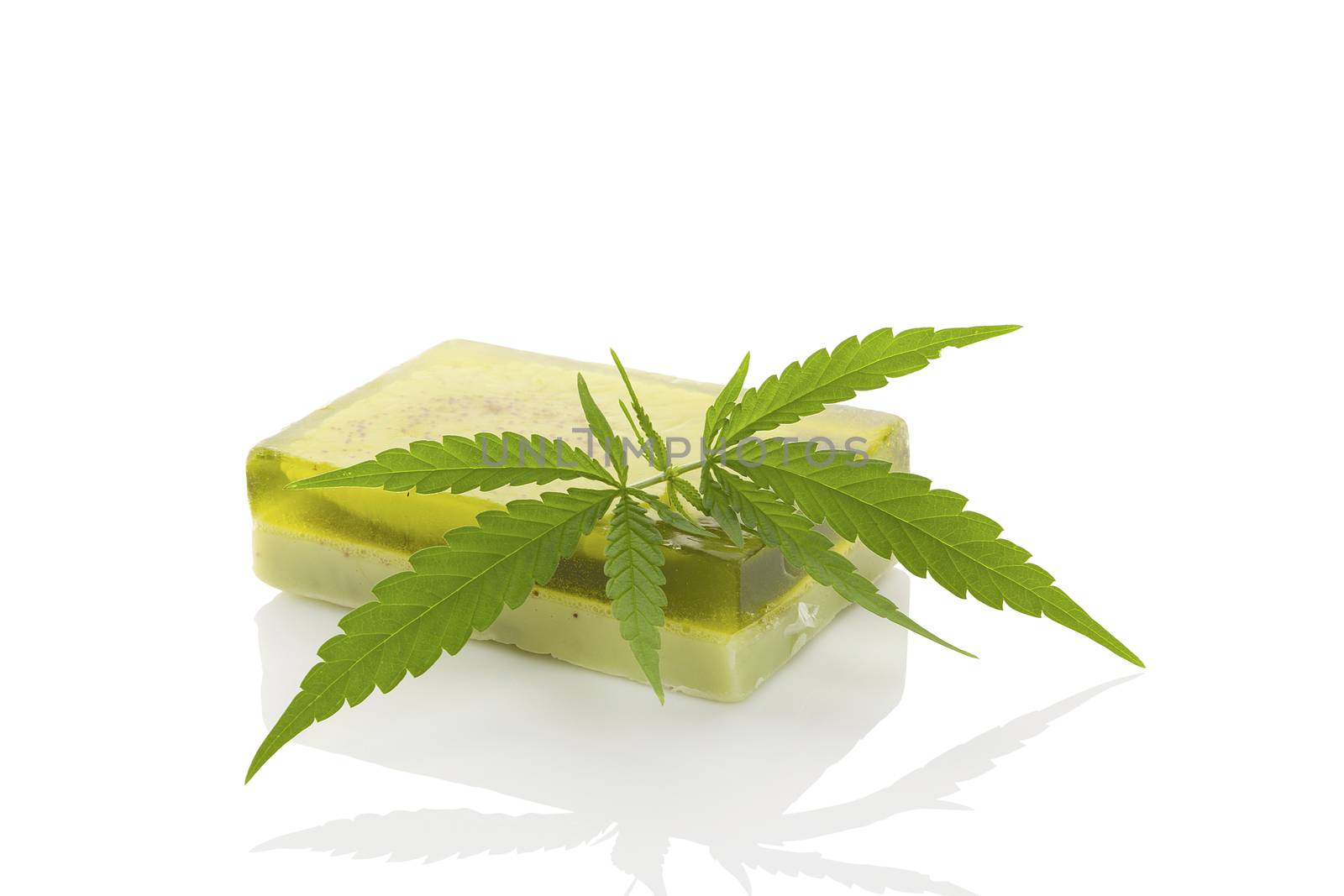 Green hemp soap and hemp leaf isolated on white background. Cannabis cosmetics. Ecological healthy skin care.