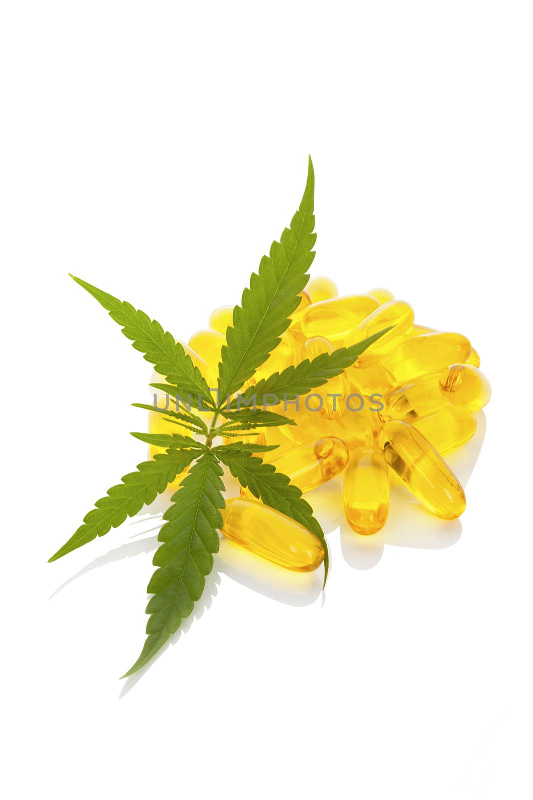 Medical marijuana. Cannabis leaf and tablets isolated on white background.