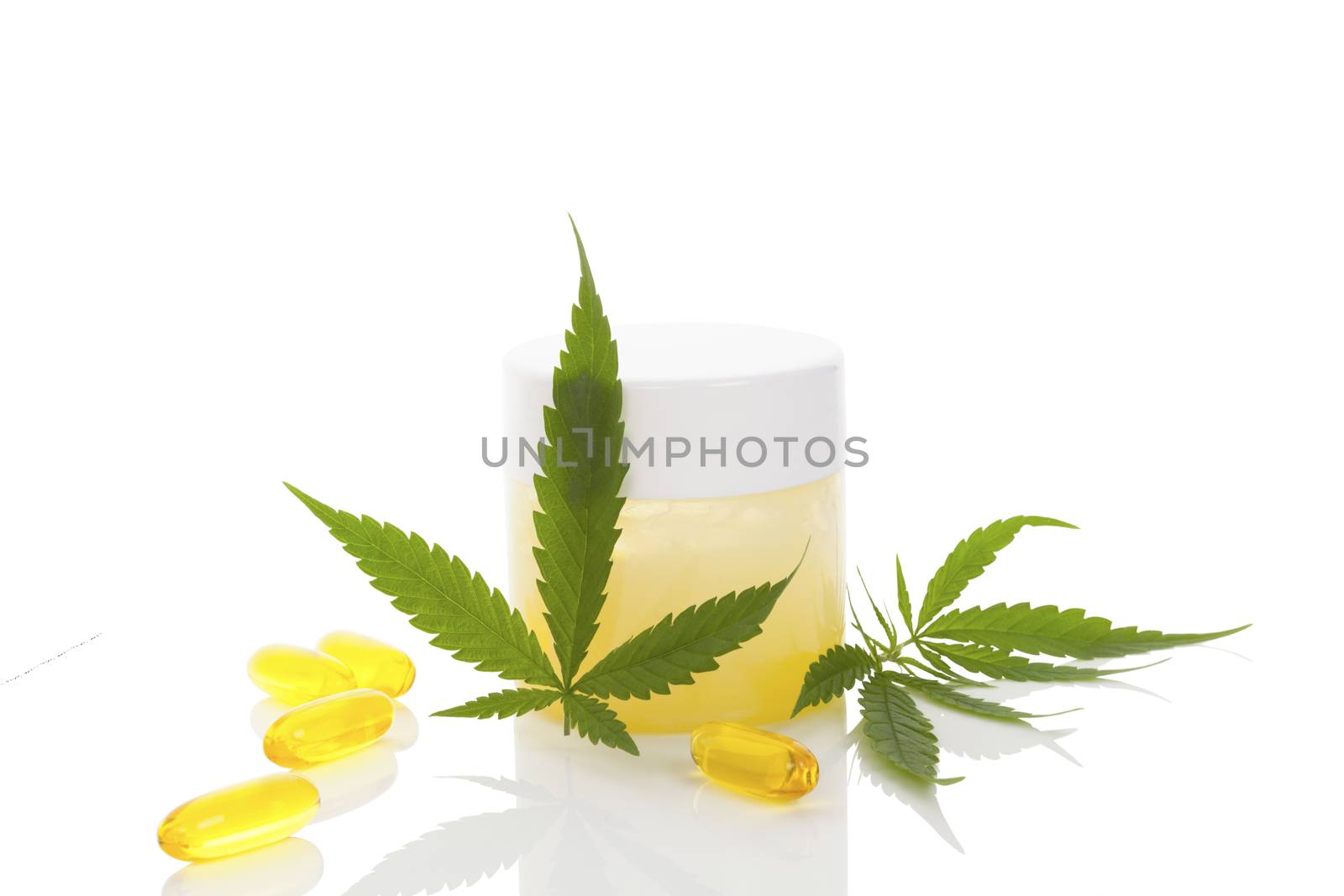 Medical marijuana. Cannabis leaf and tablets isolated on white background.