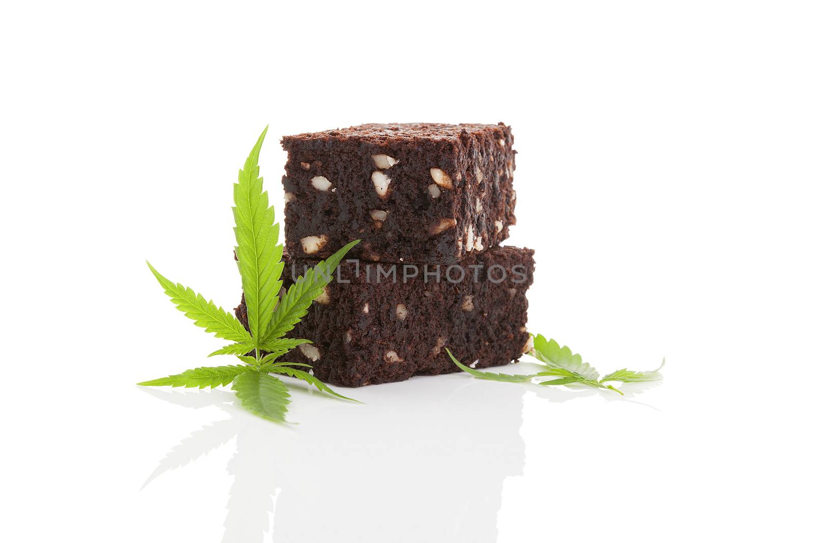 Delicious cannabis brownie with marijuana leaf isolated on white background. Delicious space cookie. 
