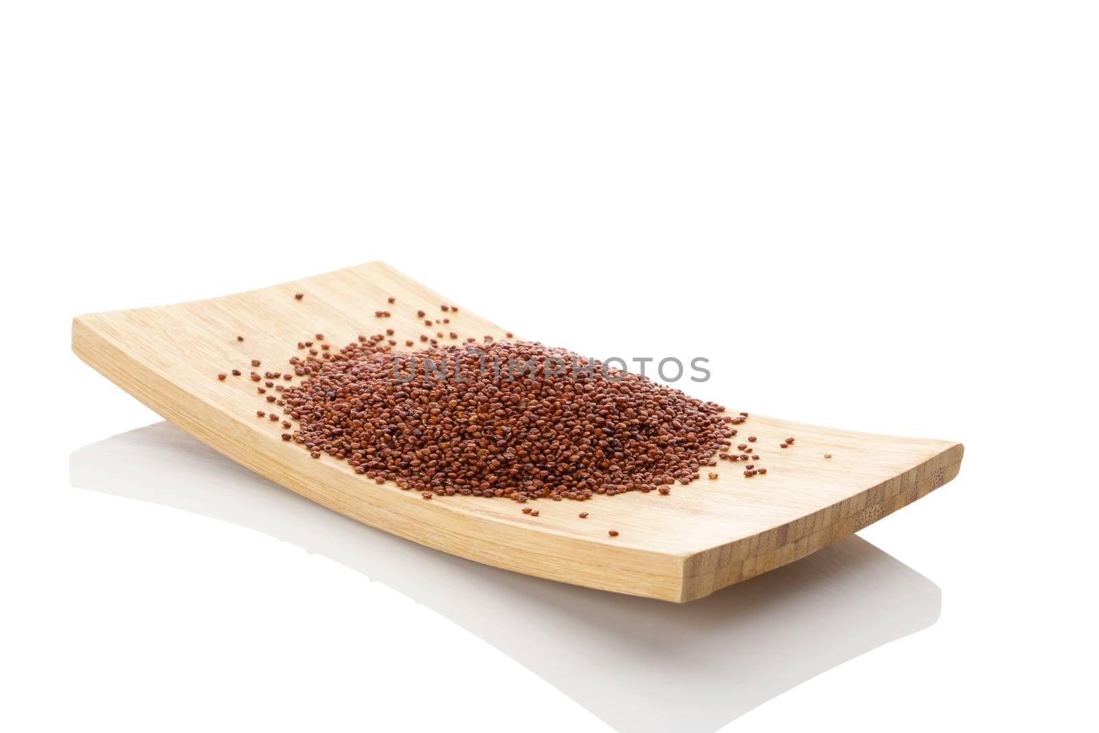 Quinoa seeds on wooden plate isolated on white background. Healthy eating, dietary supplement.