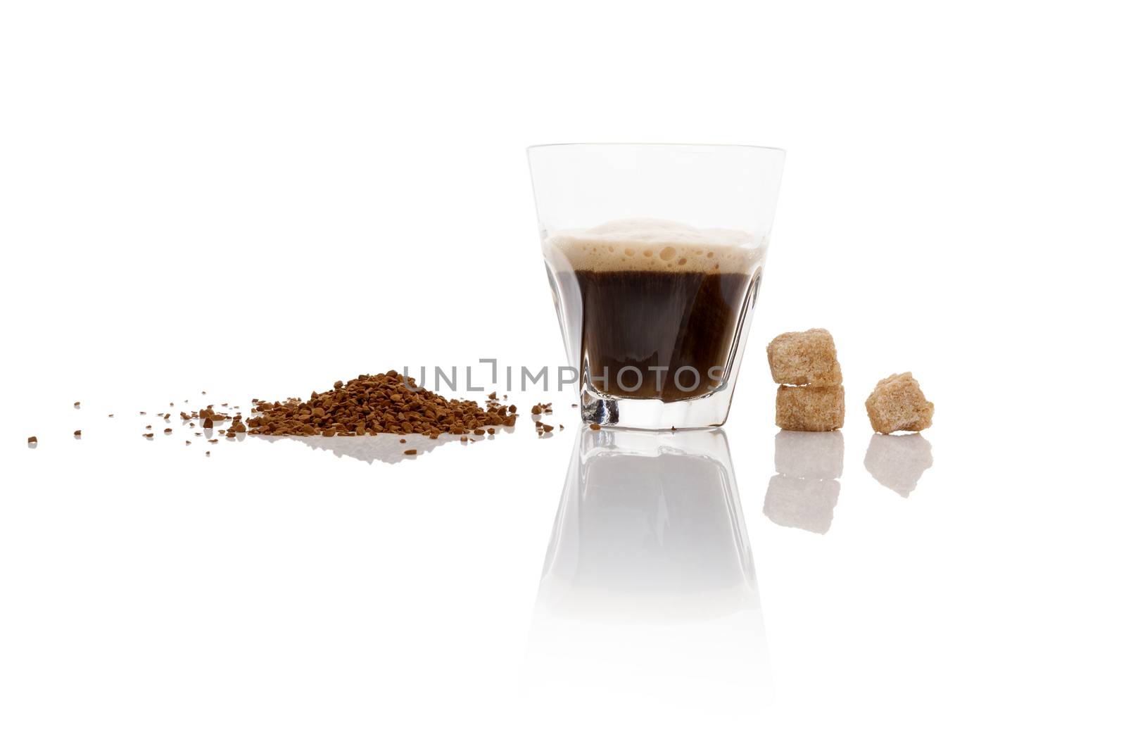 Instant coffee powder and delicious aromatic coffee in glass isolated on white background with reflection. Culinary coffee drinking. 