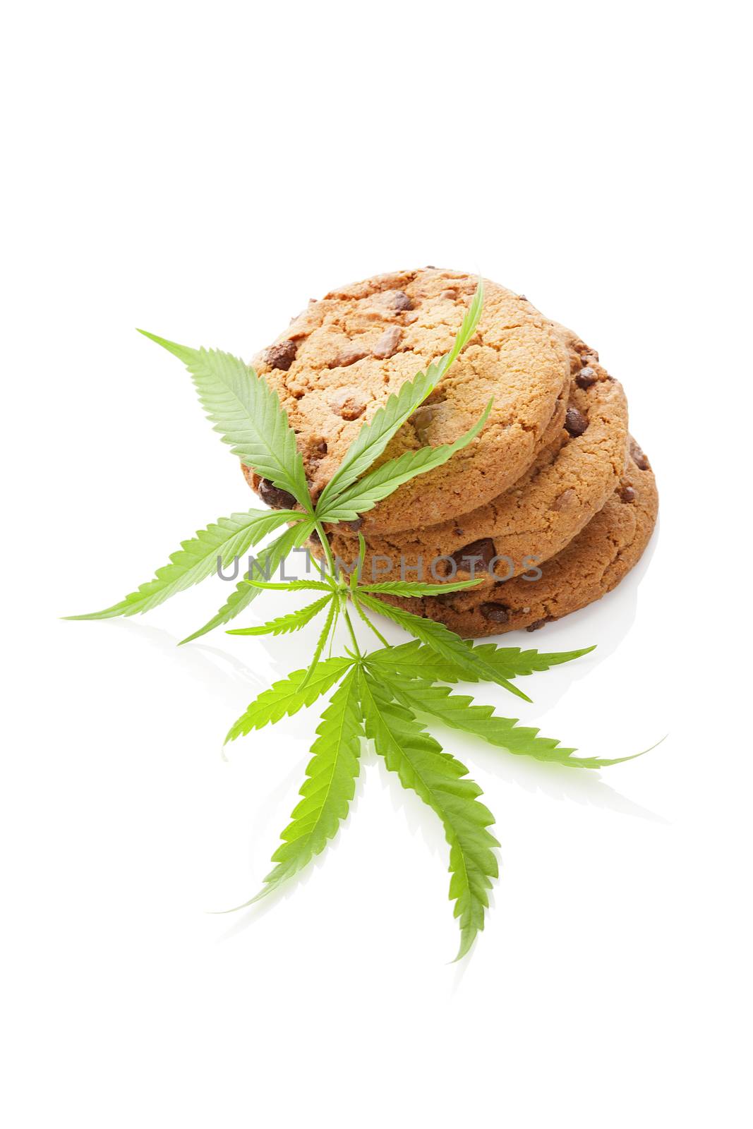 Chocolate chip cookies with marijuana leaf isolated on white background. Space cookies.