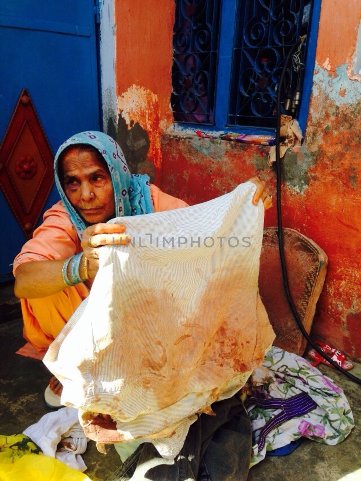 INDIA, Dadri: Asgara Begum, age 70, holds the blood soaked shirt that her son Mohammad Ikhlaq, age 52, was wearing when he was killed by a mob over rumors that the family had been storing and consuming beef at their home in Dadri, Uttar Pradesh, India on October 1, 2015. Her 22-year-old son Danish was also seriously injured in the attack and is battling for his life in a Noida hospital.  		