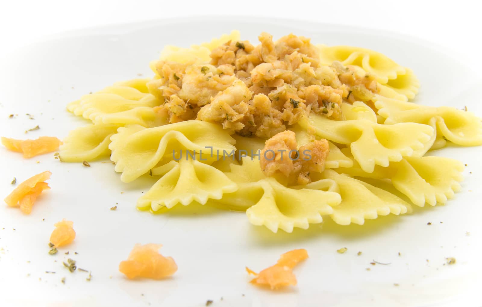 italian traditional pasta called butterflies with shrimp salmon and basil