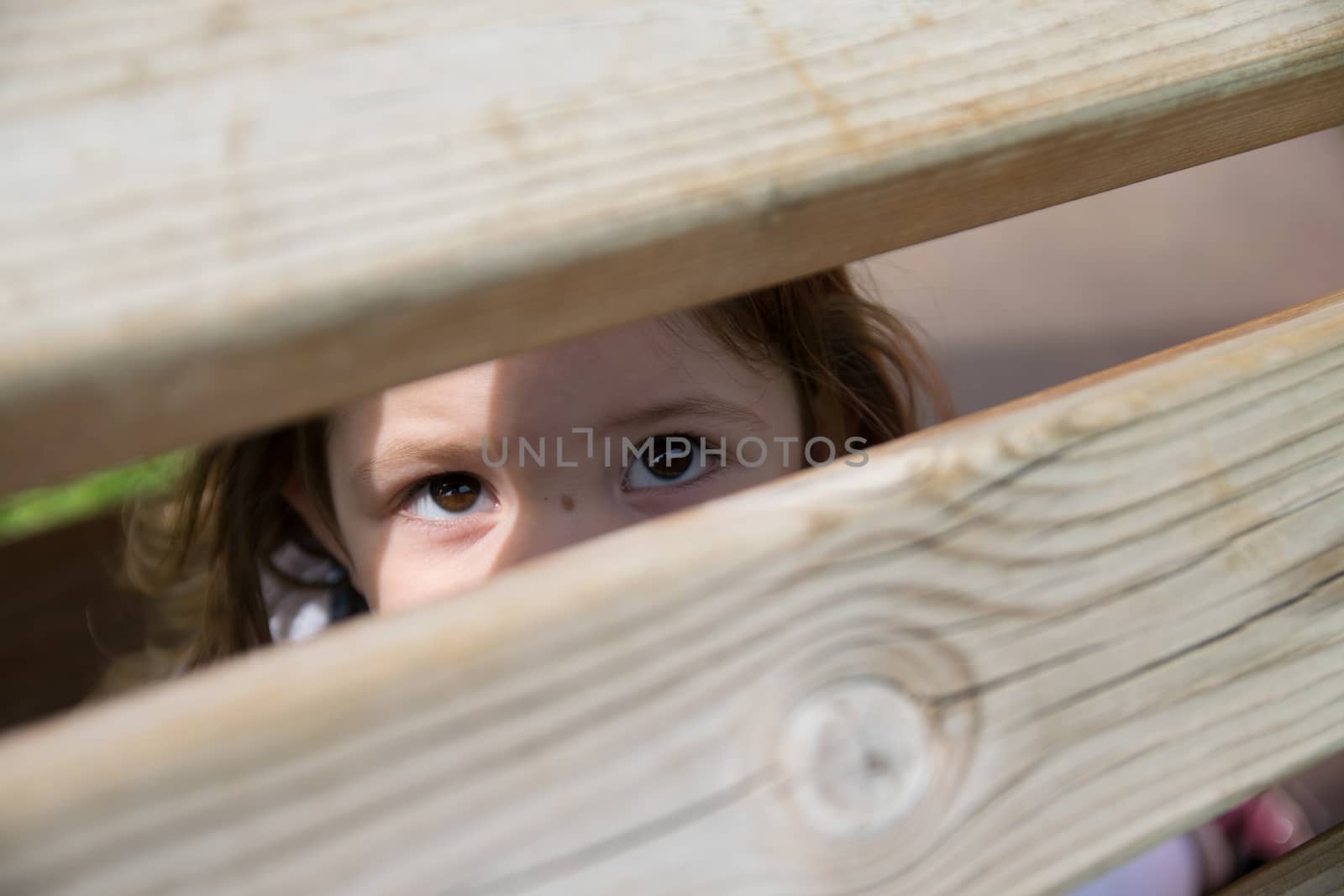 baby looks through wood aces by Isaac74