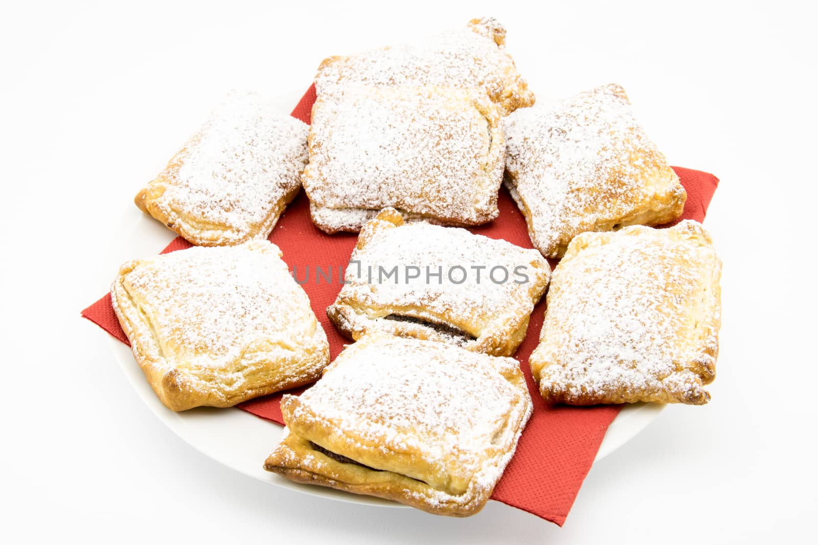 handmade biscuits of puff pastry stuffed with chocolate and covered with powdered sugar