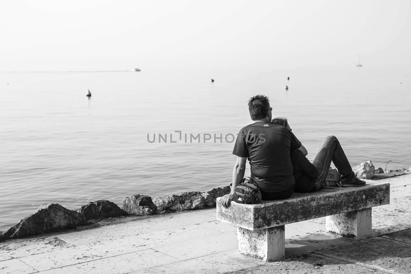 lovers on the bench in front of the lake