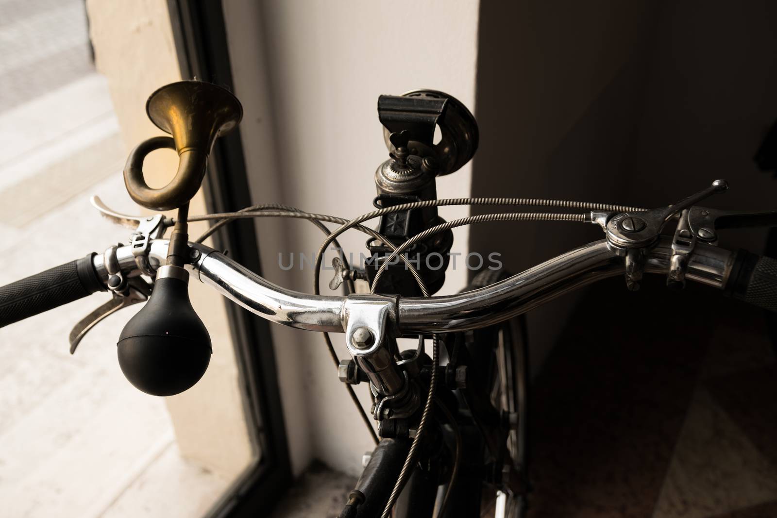 handlebar with horn like a trumpet and acetylene headlight of a vintage moped