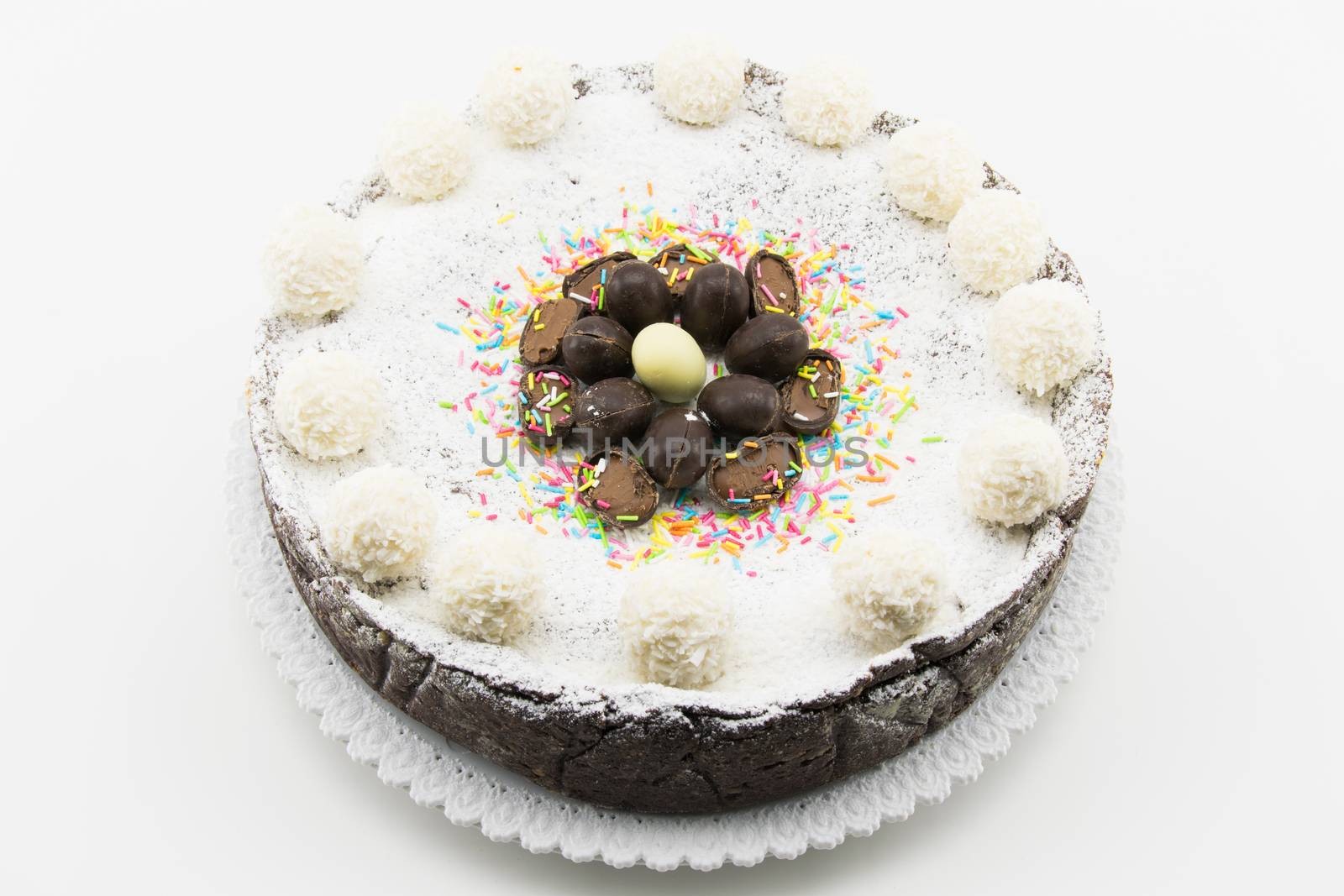 Easter cake with ricotta and chocolate decorated with chocolate eggs and powdered sugar