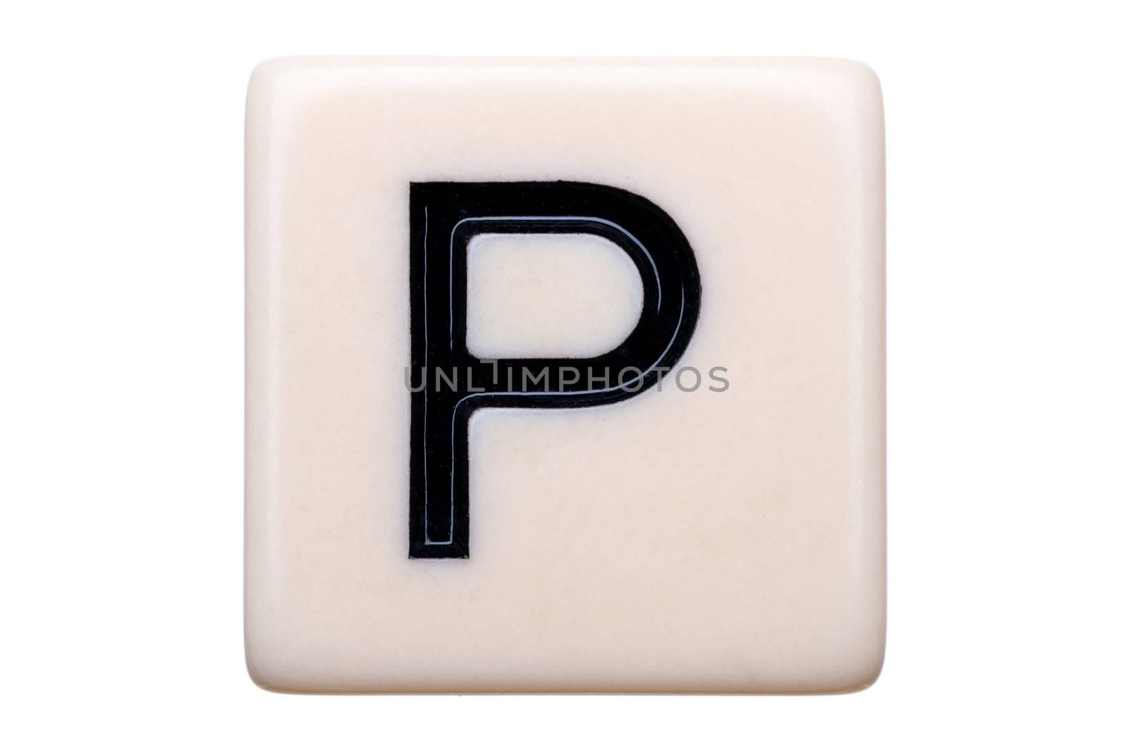 A macro shot of a game tile with the letter P on it on a white background.