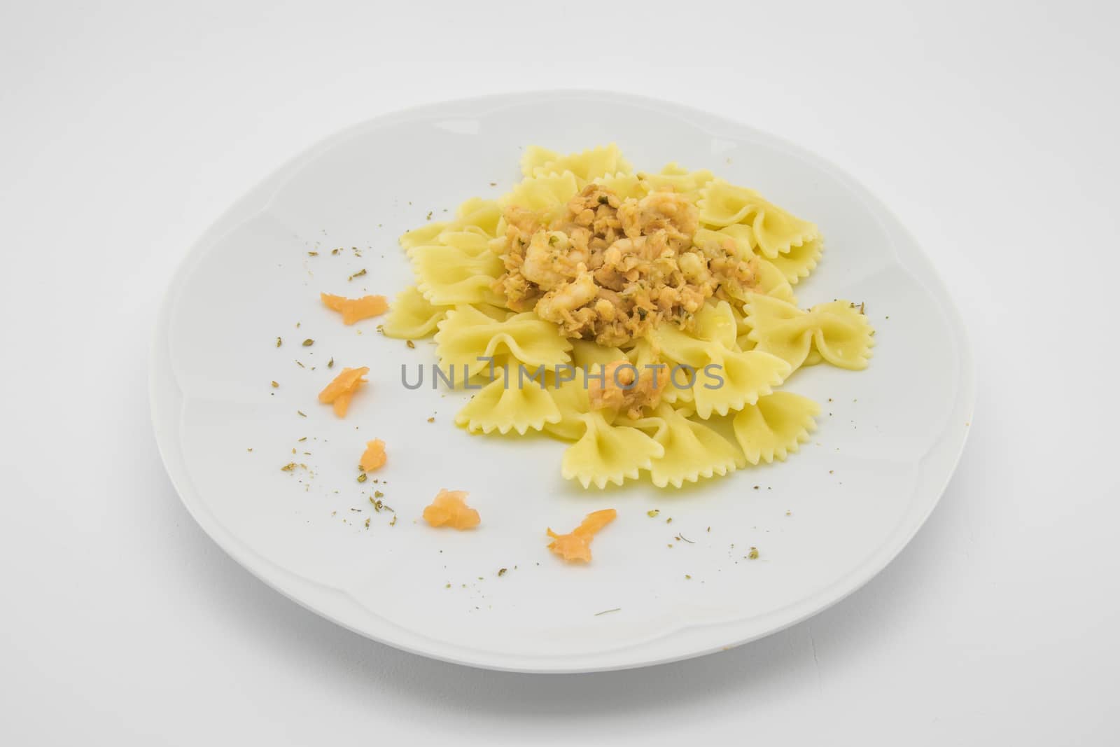 italian traditional pasta called butterflies with shrimp salmon and basil