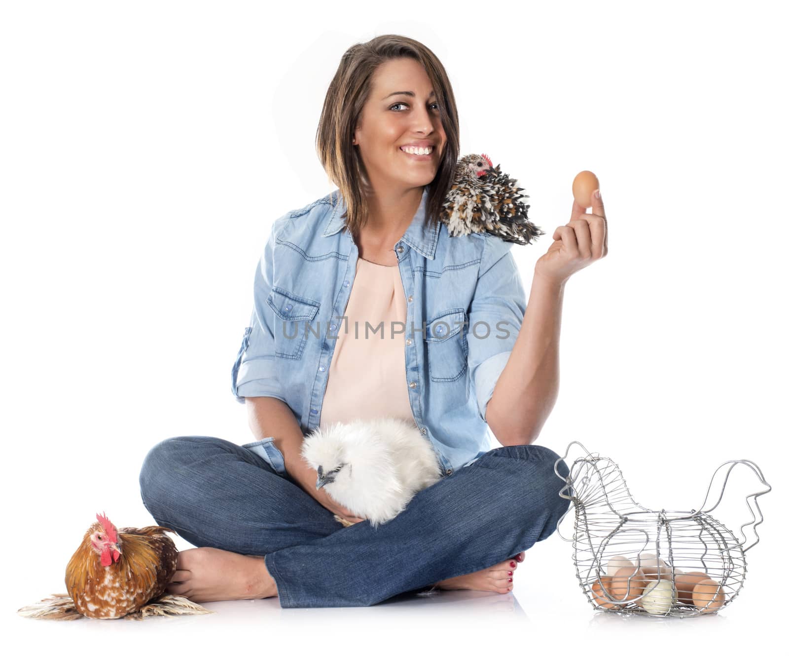 young woman and chicken in front of white background