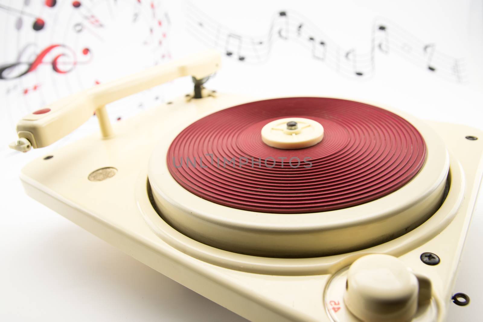 composition with vintage red record player and musical notes on background