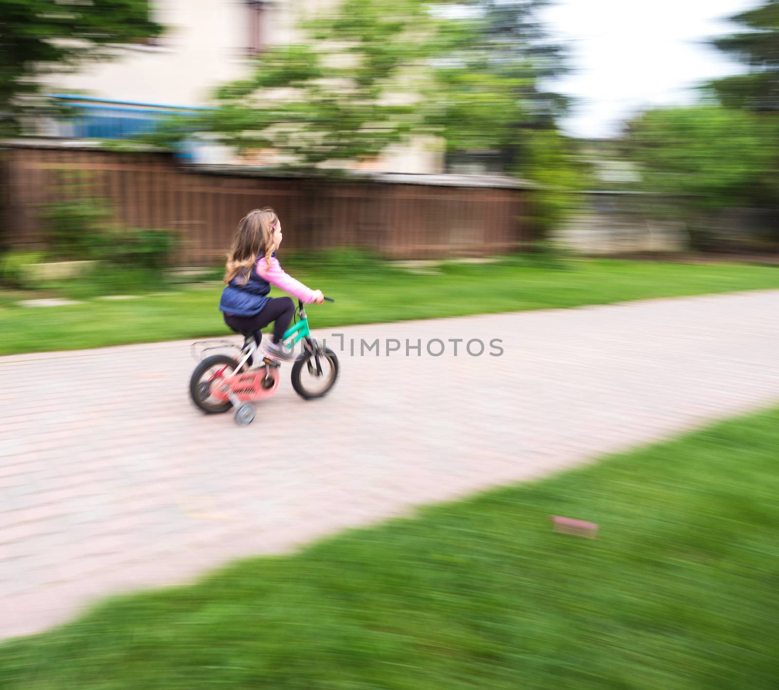 little girl ride fast on bike with casters