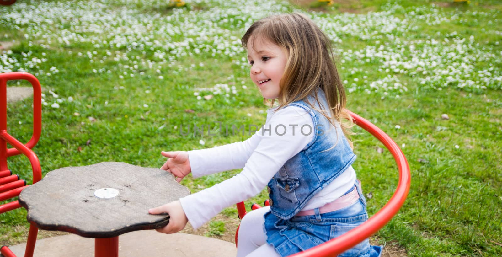 little girl turns into a red carousel in an outdoor playground by Isaac74