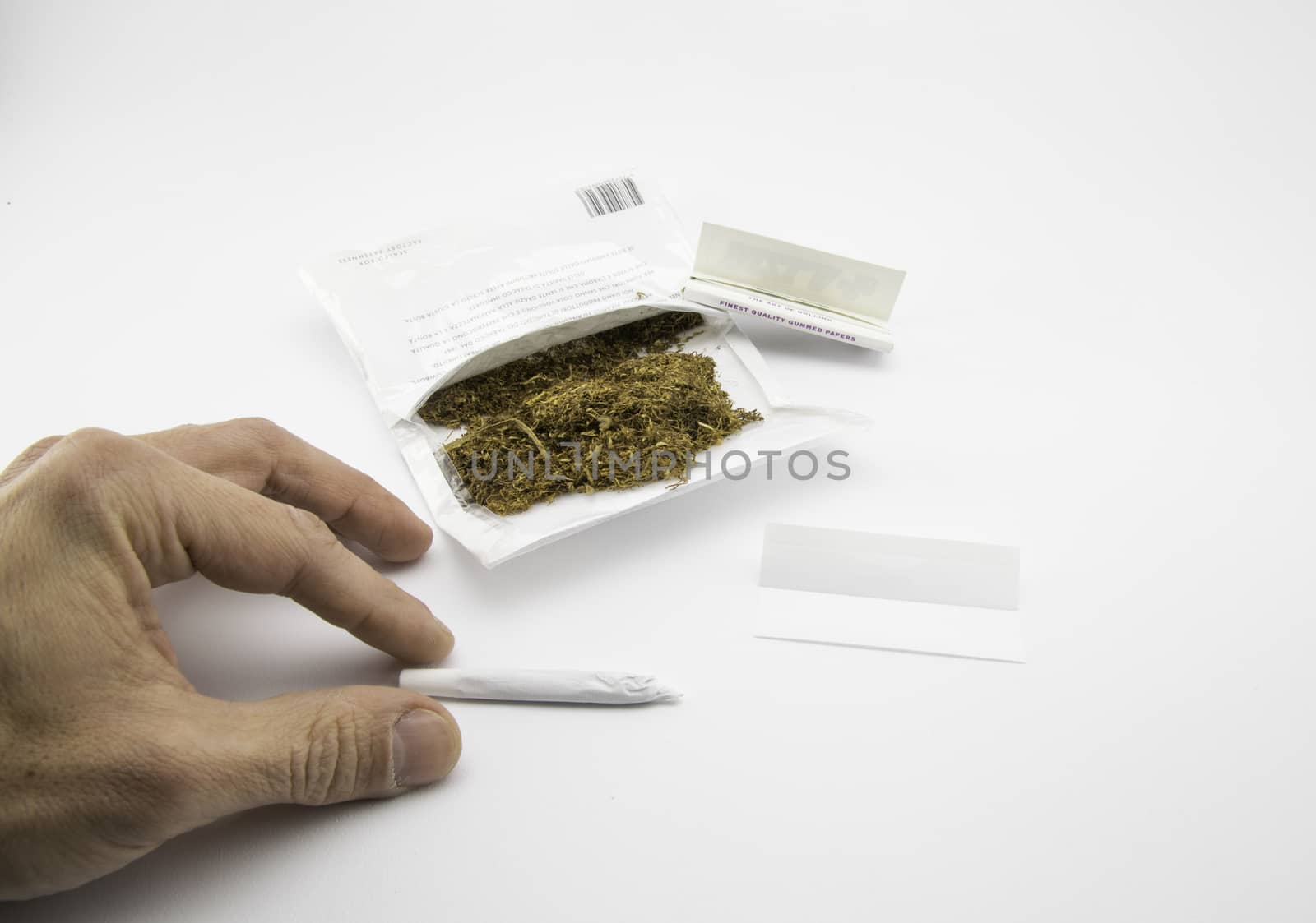 ready for smoking a handmade cigarette on white background