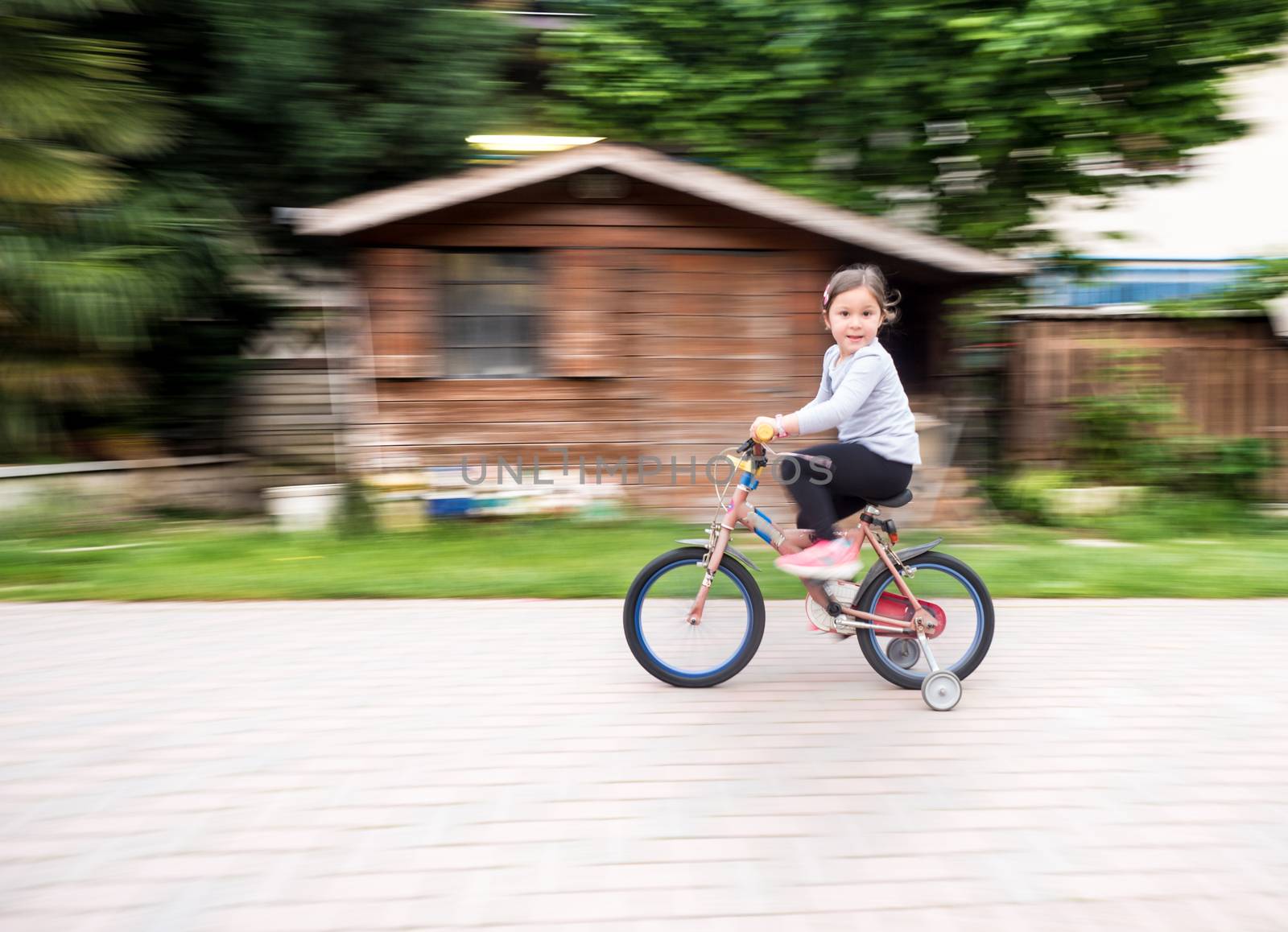 little girl ride fast on bike with casters