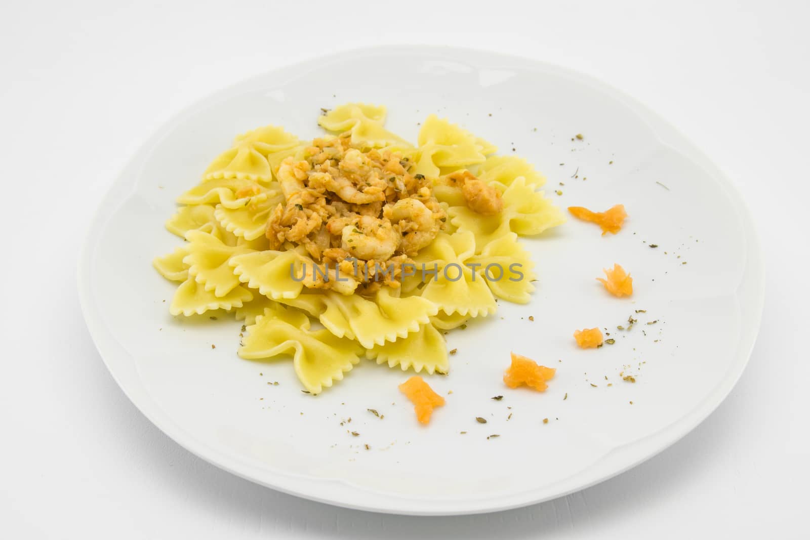 italian traditional pasta called butterflies with shrimp salmon and basil