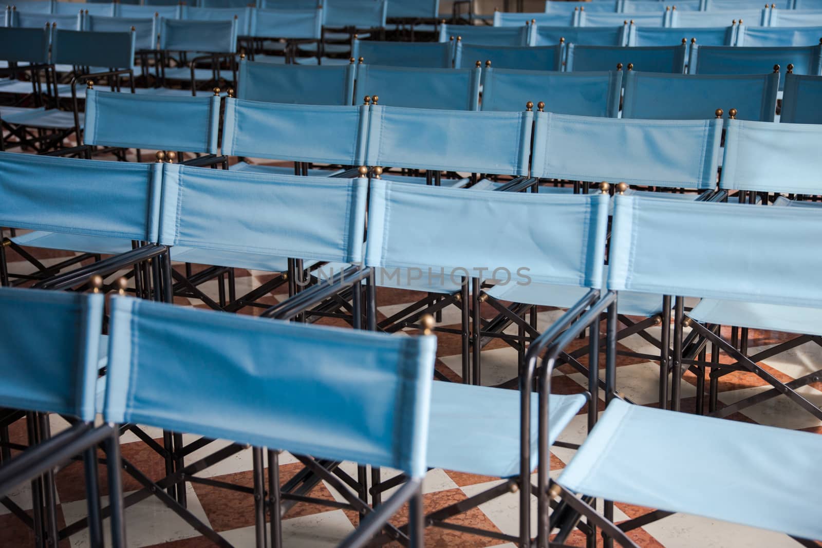 composition of blue canvas folding chairs empty