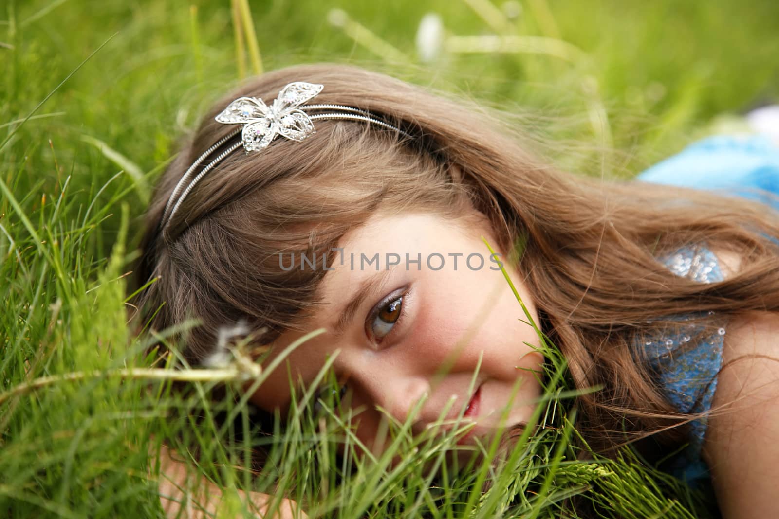 Cute little girl on the meadow in spring day