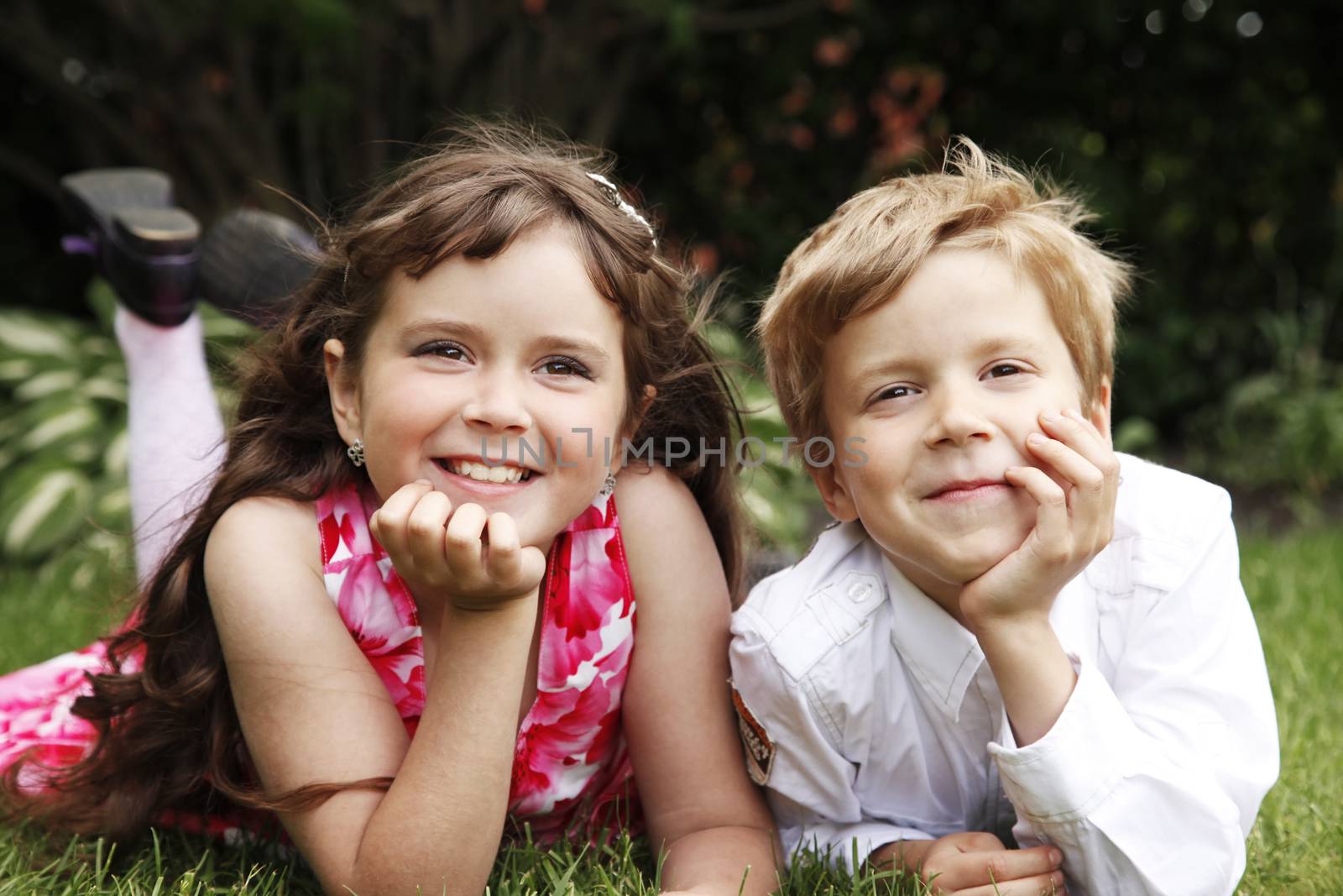 Brother and sister outdoors smiling