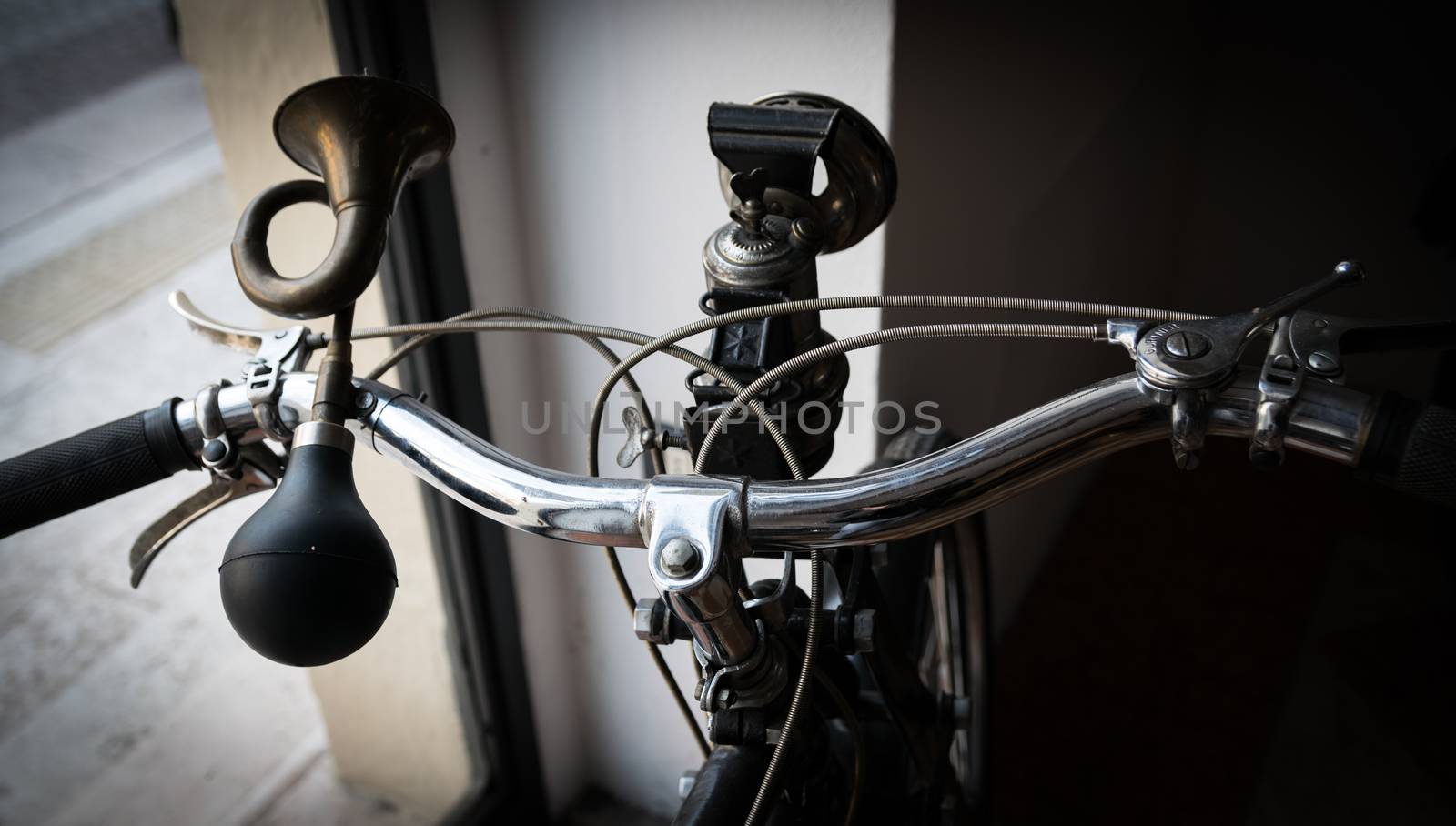 handlebar with horn like a trumpet and acetylene headlight of a vintage moped