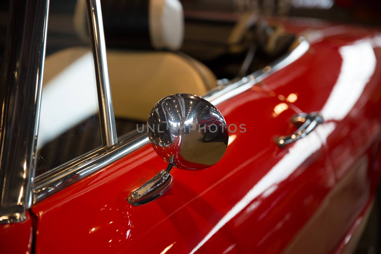 Chrome rearview mirror of a red car