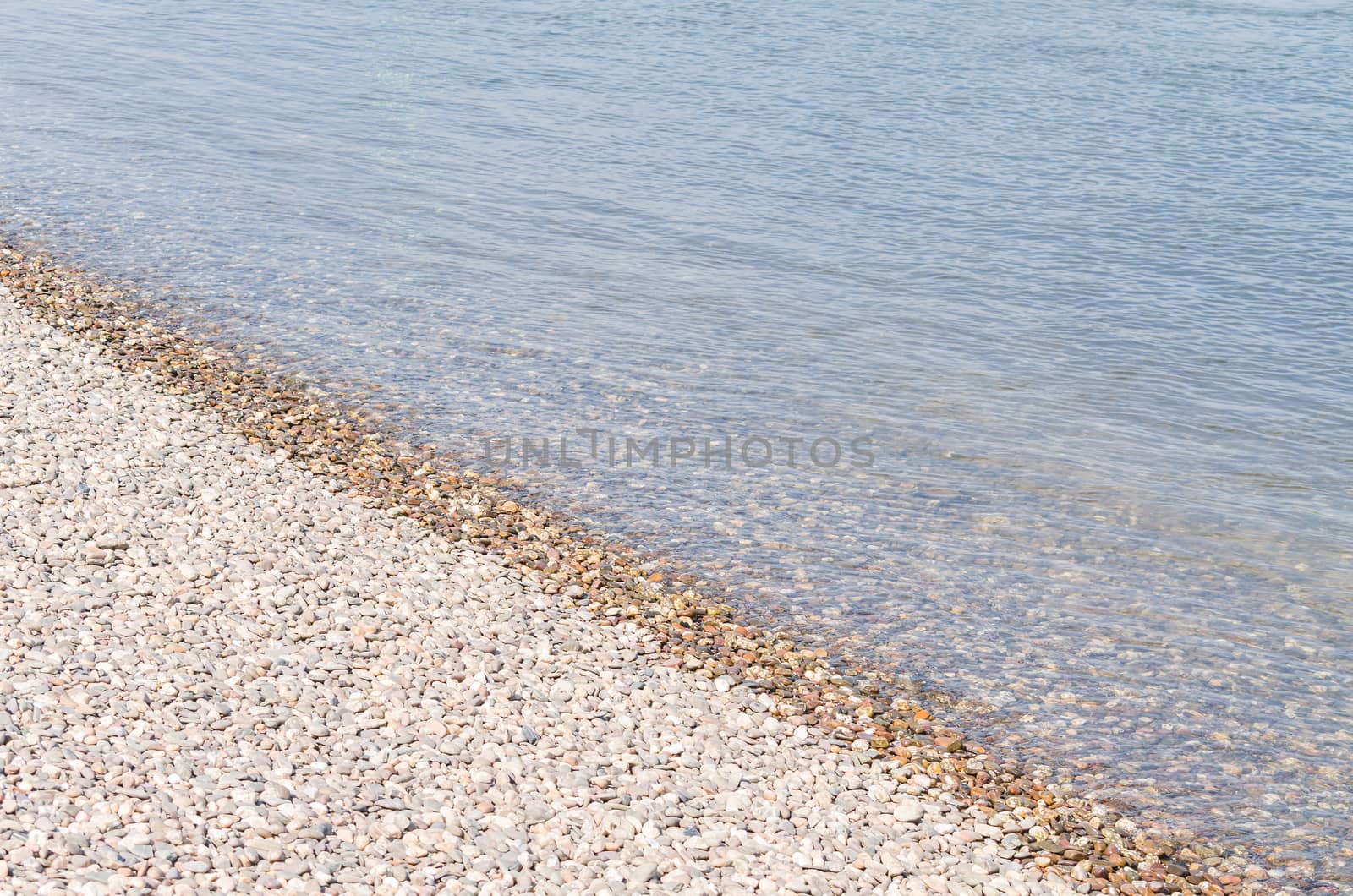 Beautiful waterside scenery with little stones on a river.