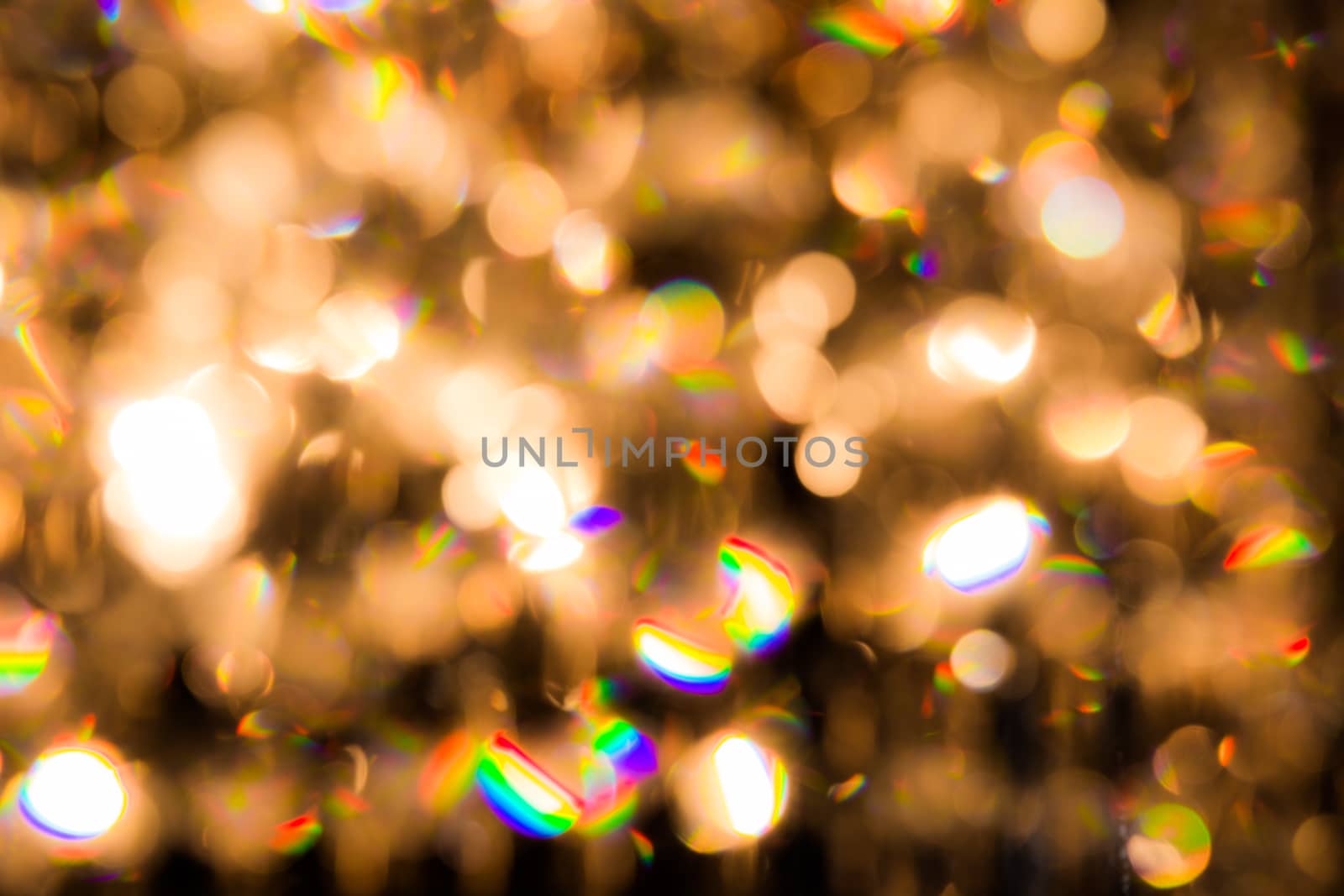 background created by a crystal chandelier that shines with golden light