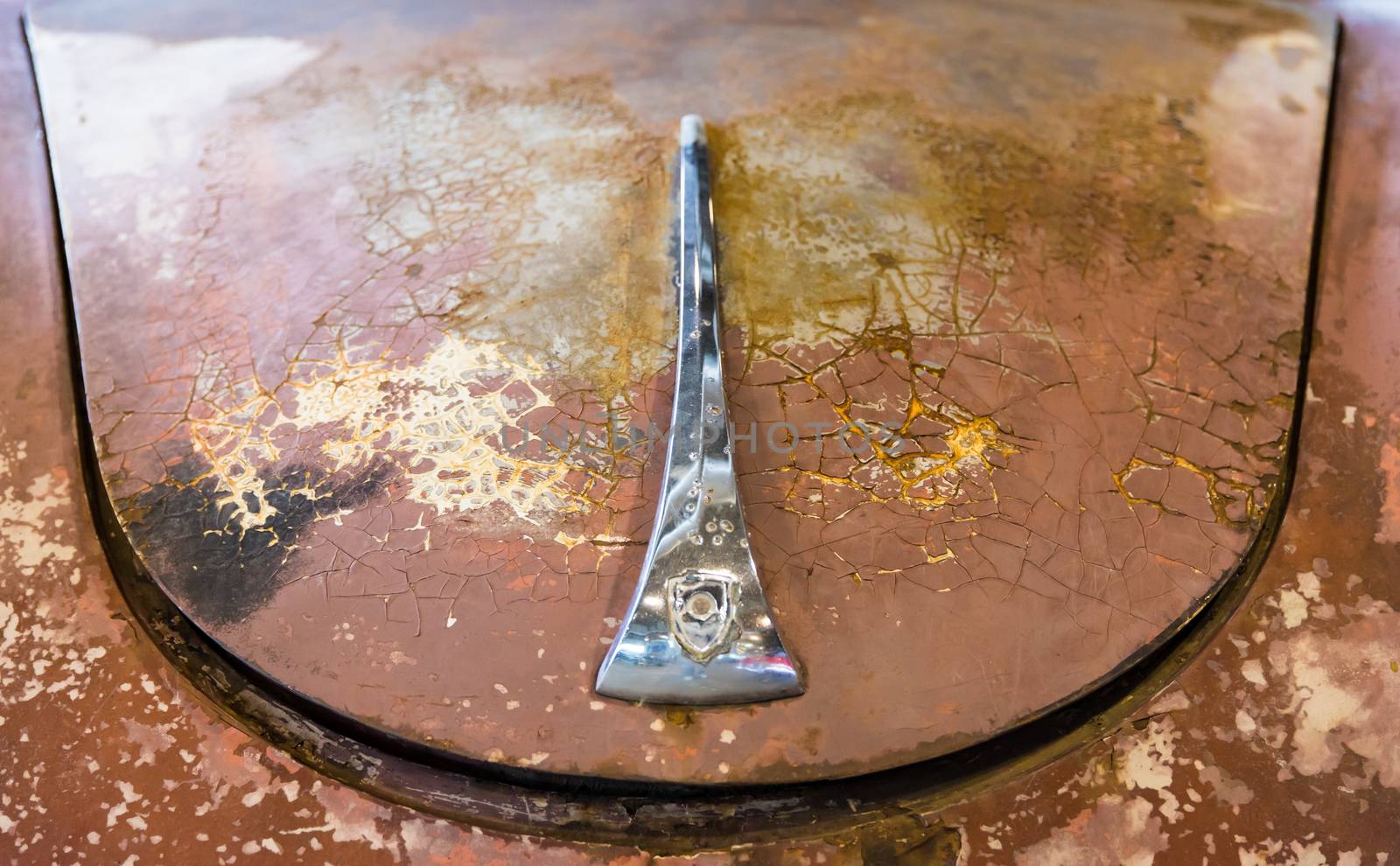 the hood of a rusty old car to be restored