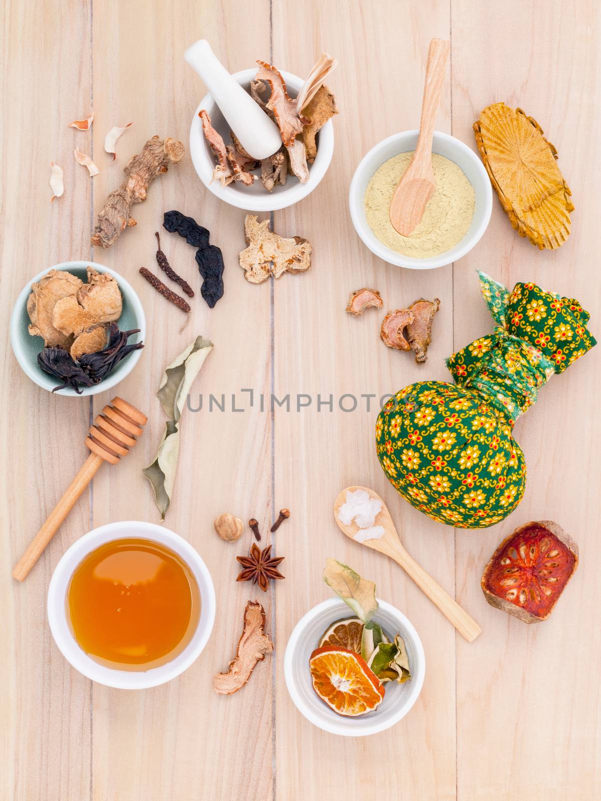 Natural Spa Ingredients herbal compress ball and herbal Ingredients for alternative medicine and relaxation Thai Spa theme with wooden background.
