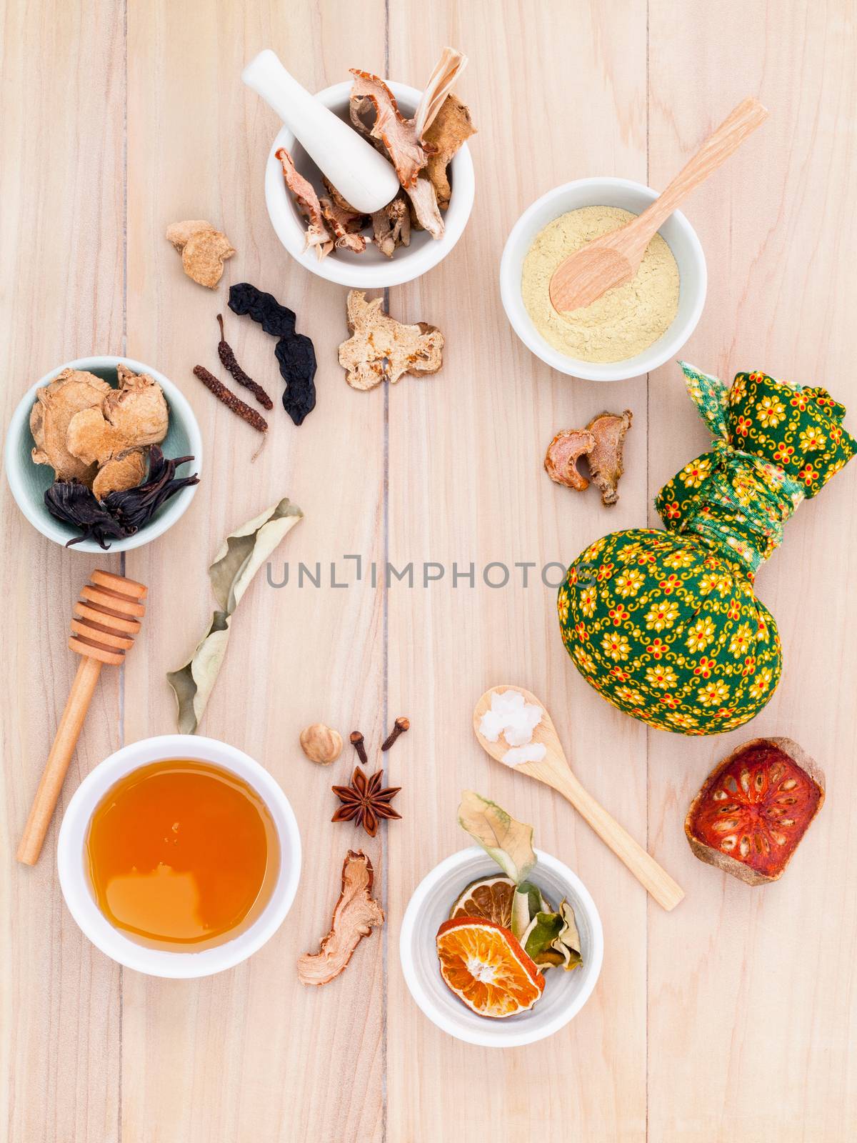 Natural Spa Ingredients herbal compress ball and herbal Ingredients for alternative medicine and relaxation Thai Spa theme with wooden background.