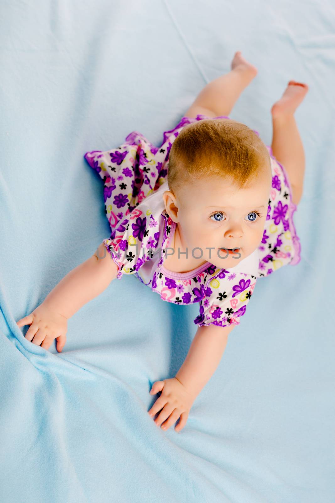 Charming baby girl in a dress. Studio