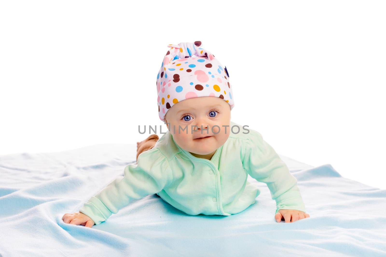 Charming baby girl in a hat. Studio