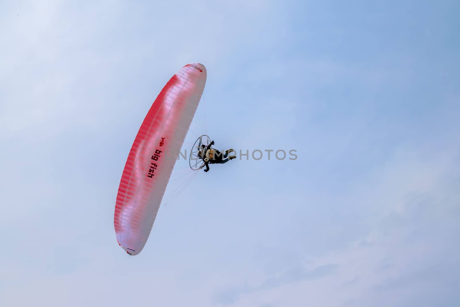 motorized paraglider flying in the blue sky by Isaac74