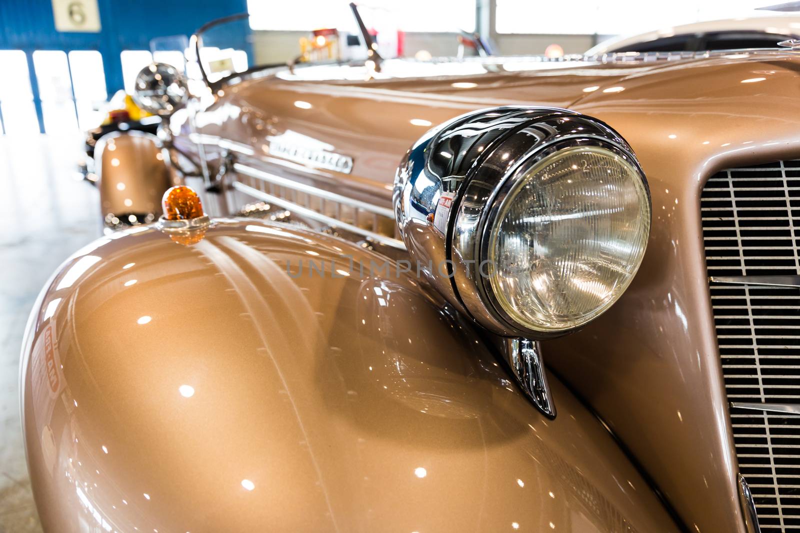 rounded lines and round headlights of a vintage car by Isaac74